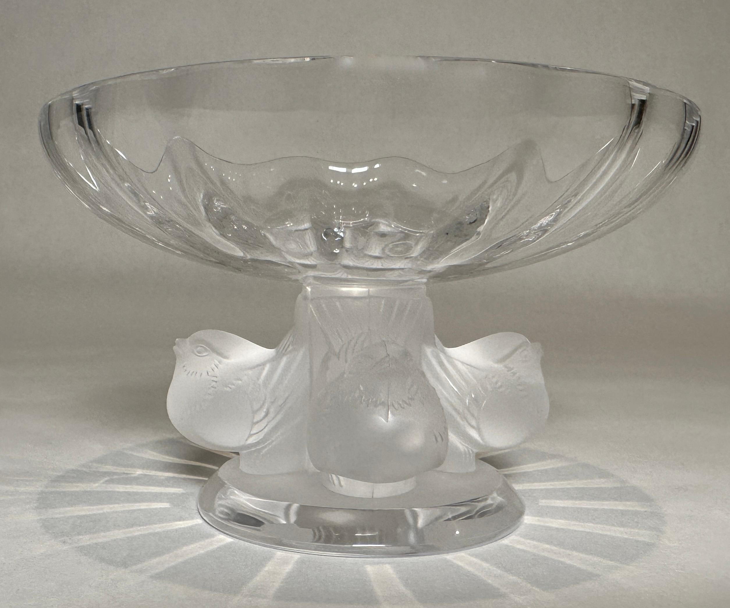 Lalique compote Nogent bowl. Signed on bottom.
Designed by Marc Lalique in 1966, this small bowl has become a Lalique classic. The satin finish on the birds contrasts with the transparency of the bowl while the purity of crystal echoes the glare of