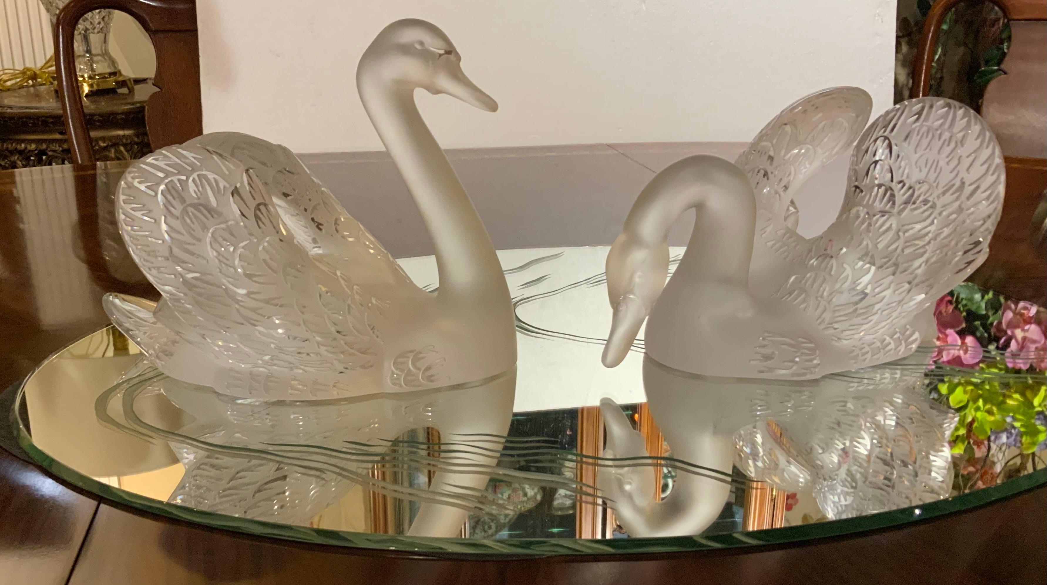 This is a set of three, two Lalique swans and mirror oval
Centerpiece. “Mirror cygnes��”, original design by Rene Lalique
(French, 1860-1945), comprising ( 2) swans on (1) etched
Ovular mirror plateau, swans bearing engraved makers mark,
One numbered