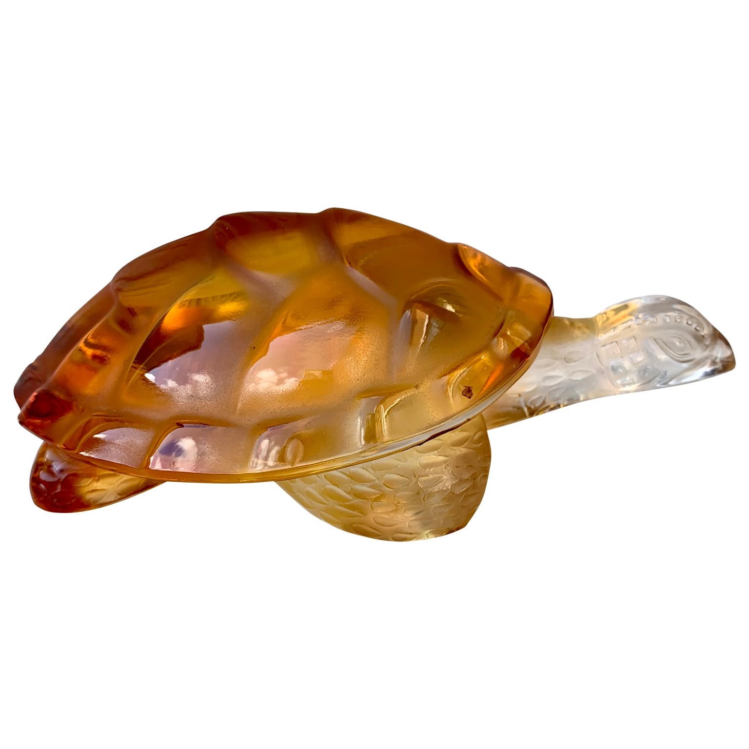 A Vintage figurine or letter weight in clear and amber crystal glass Caroline tortoise signed on the bottom 