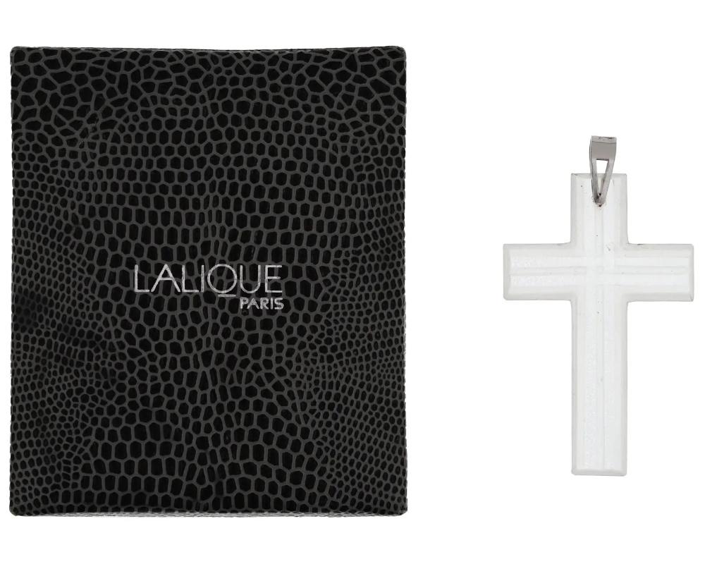 A crystal Catholic cross pendant by Lalique. The piece is decorated with etched accents. Silver suspension ring. The item comes in original box. Lalique is a French homeware, jewelry, and perfume manufacture established in 1885. Luxury Jewelry And