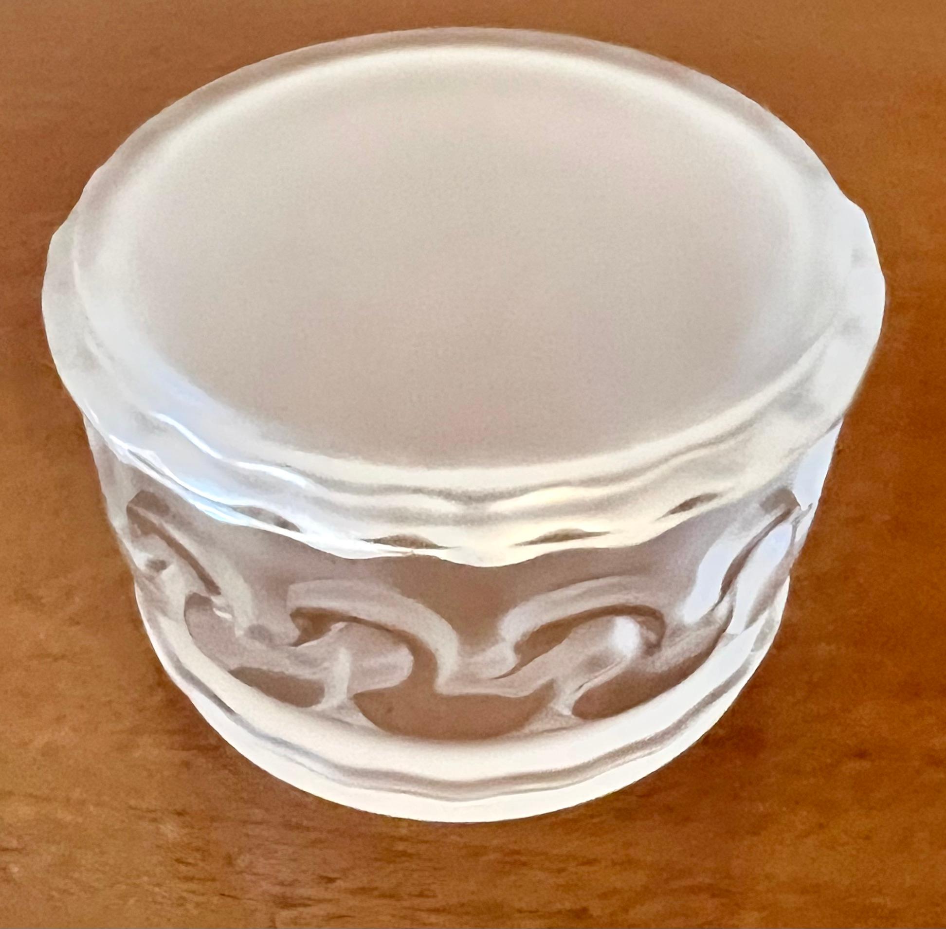 a special Lalique Paris frosted glass lidded box.

Could be used for any vanity supplies, cotton balls, etc., or on a desk or work station for office supplies, or on a cocktail table or bedside for candies, breath mints or to store rings, or even