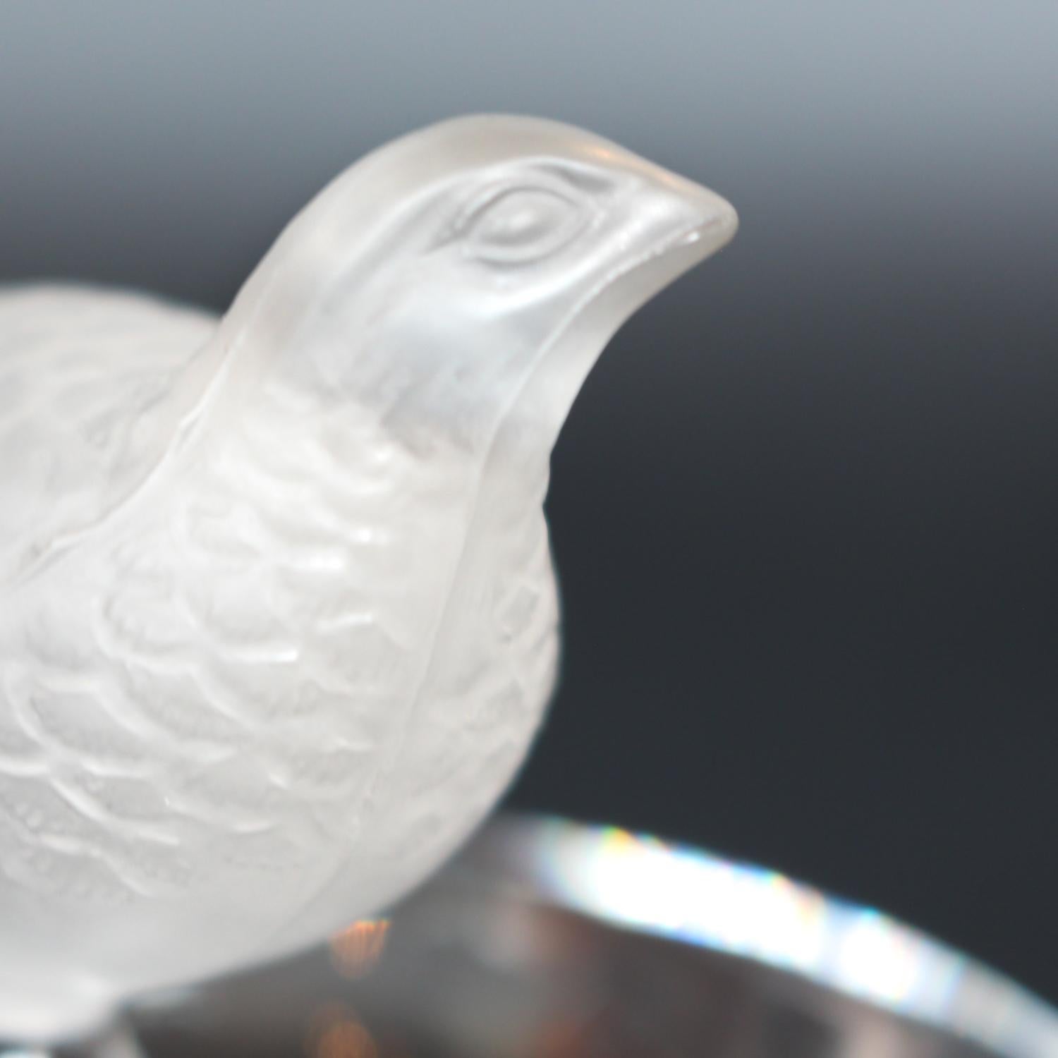 Detailed crystal ring dish by Lalique. Clear dish base topped with a frosted crystal Partridge. Signed to base.
Date: Post 1945.
 