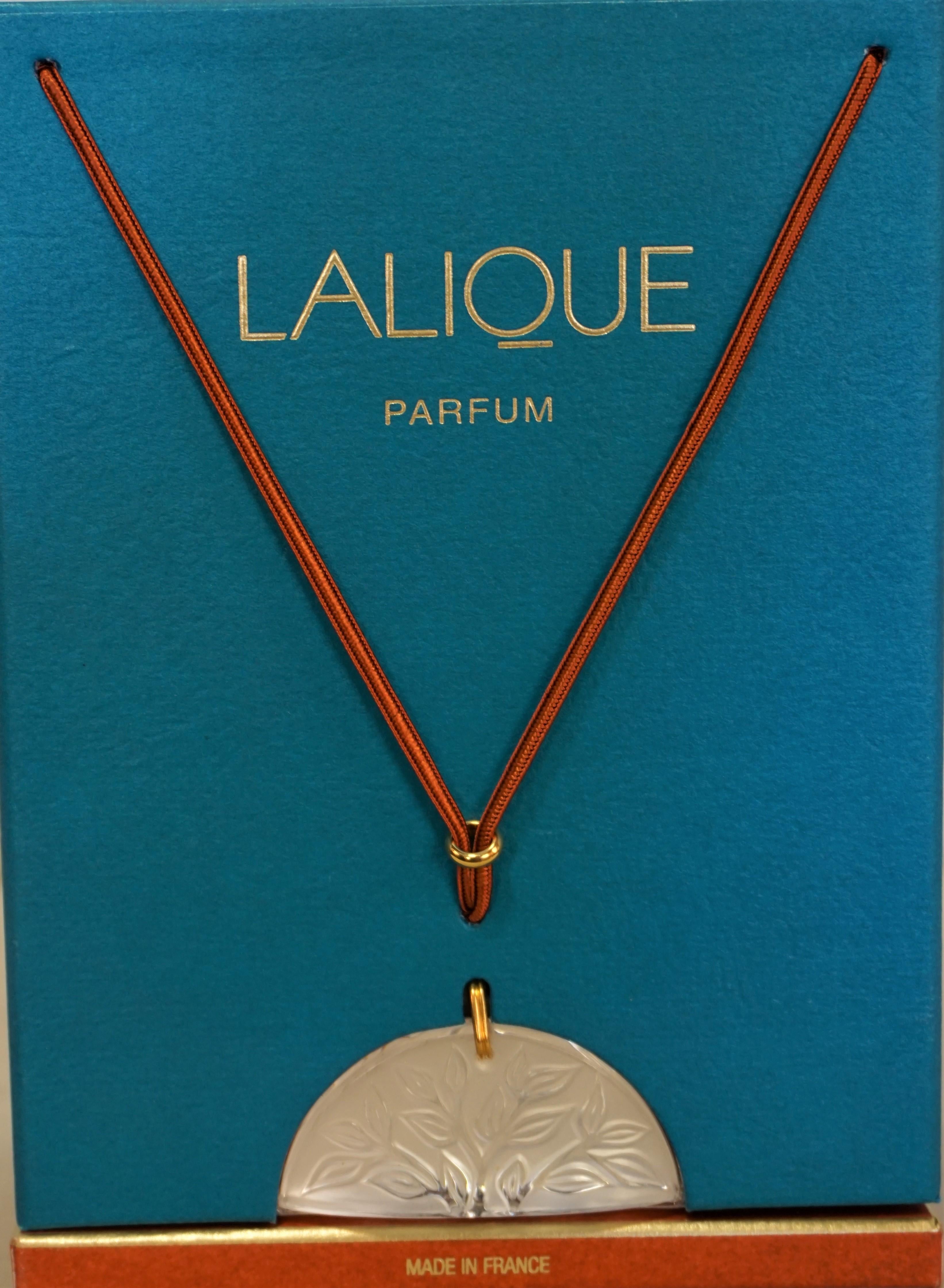 Vintage Lalique unopened perfume bottle with crystal pendant in original presentation box measuring.