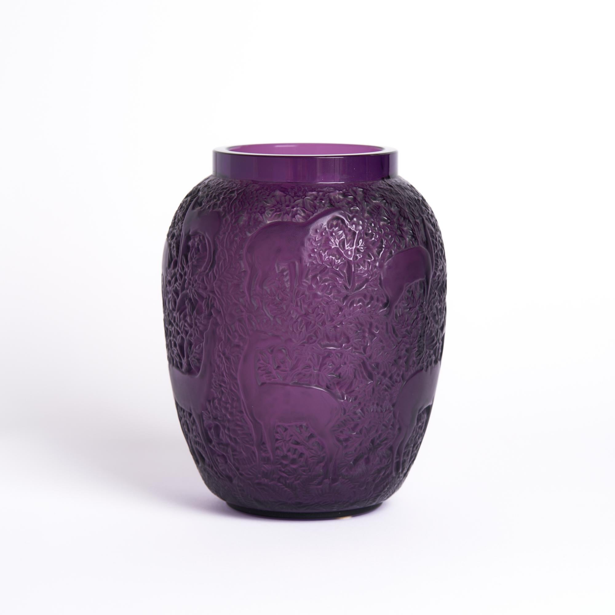 Lalique Purple Glass Biches Vase

This vase measures: 5.5 wide x 5.5 deep x 6.75 inches high and is in Great Vintage Condition

We take our photos in a controlled lighting studio to show as much detail as possible. We do not photoshop out