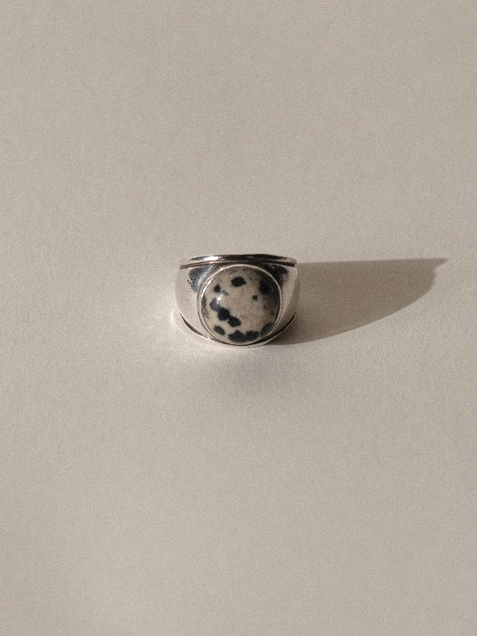 1980's or 1990's Lalique Sterling Silver Band with Dalmatian Jasper Dome
Signed Lalique
Size 6.5
Weighing 9.1 grams
Dalmatian Jasper is actually Dalmatian Stone, a form of quartz rock with a playful black and neutral spotted color pattern

Condition