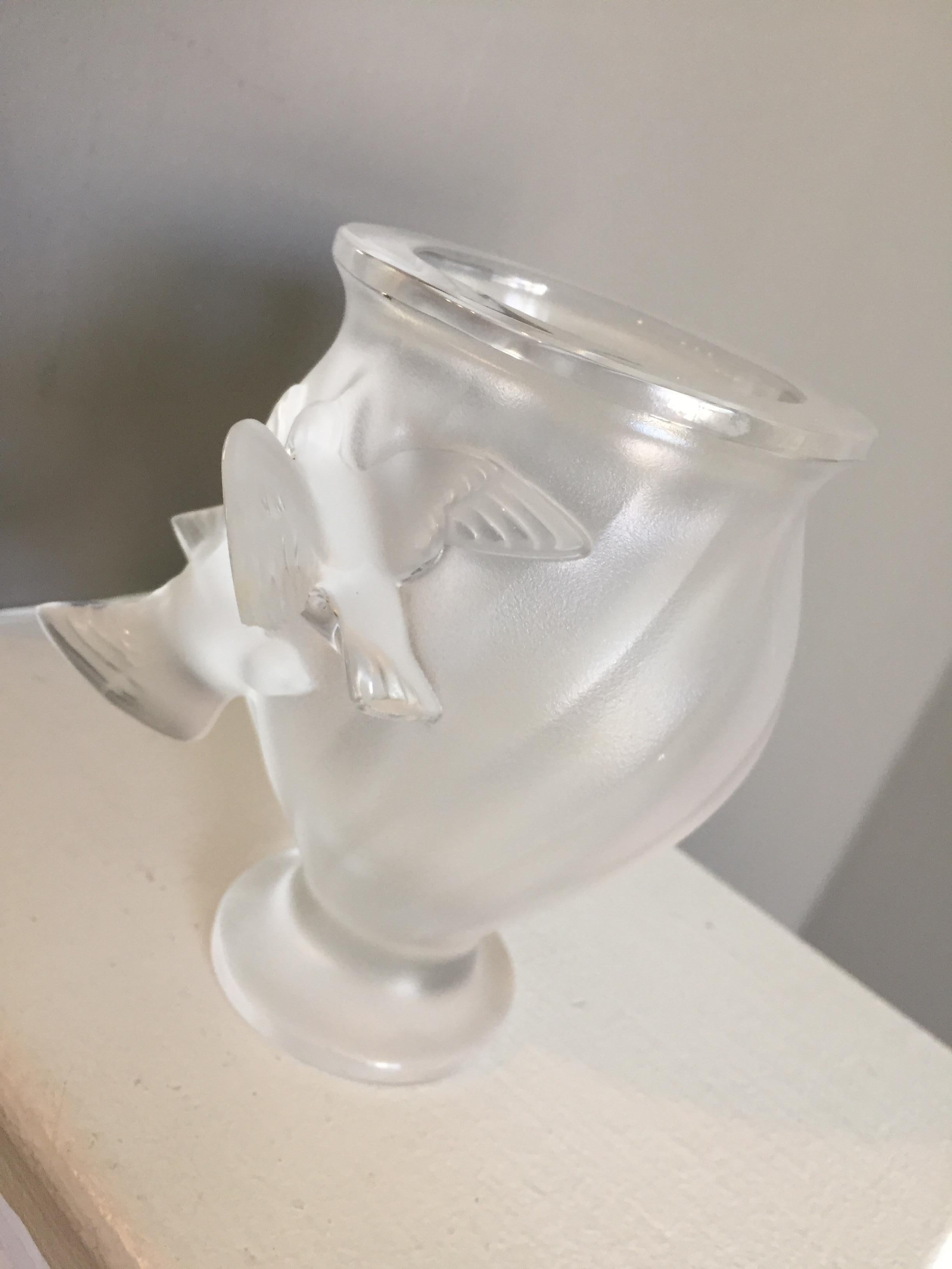 Lalique Rosine vase
The smaller version of Rosine vase with flying doves in relief by Lalique.
This wonderful vase features an all-over molded swirl design on the frosted glass body and features a beautiful pair of soaring doves in high relief on