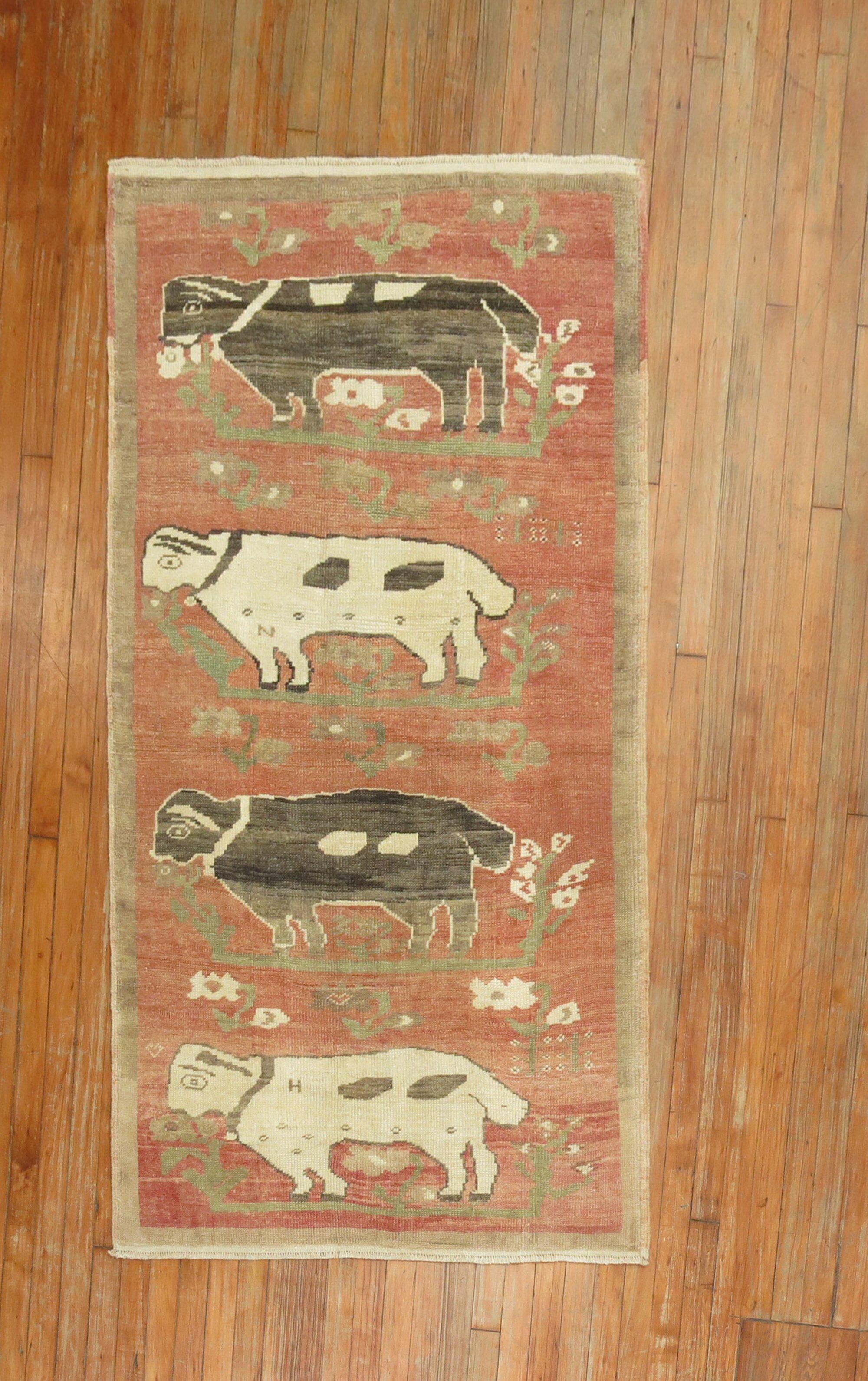 A highly decorative mid-20th century Turkish rug with lambs and sheep luring on a rose color field.

Measures: 3'5'' x 6'3'' circa 1940.