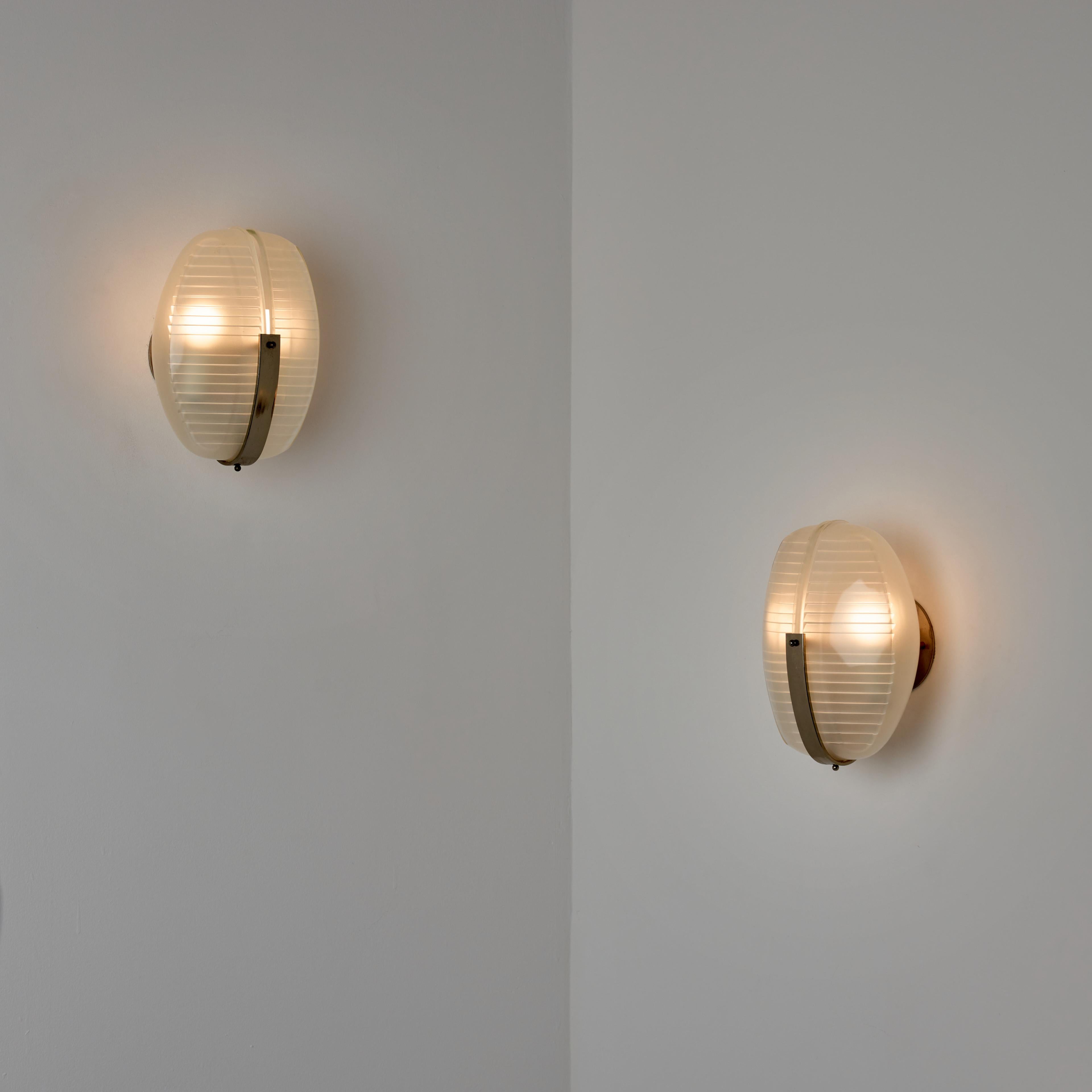 Pairs of 'Lambda' sconces by Vico Magistretti for Artemide. Designed and manufactured in Milan, Italy circa the 1960s. Two pressed crystal glass diffusers are nestled together with a patinated dark chrome armature. Rewired for U.S. standards. Holds