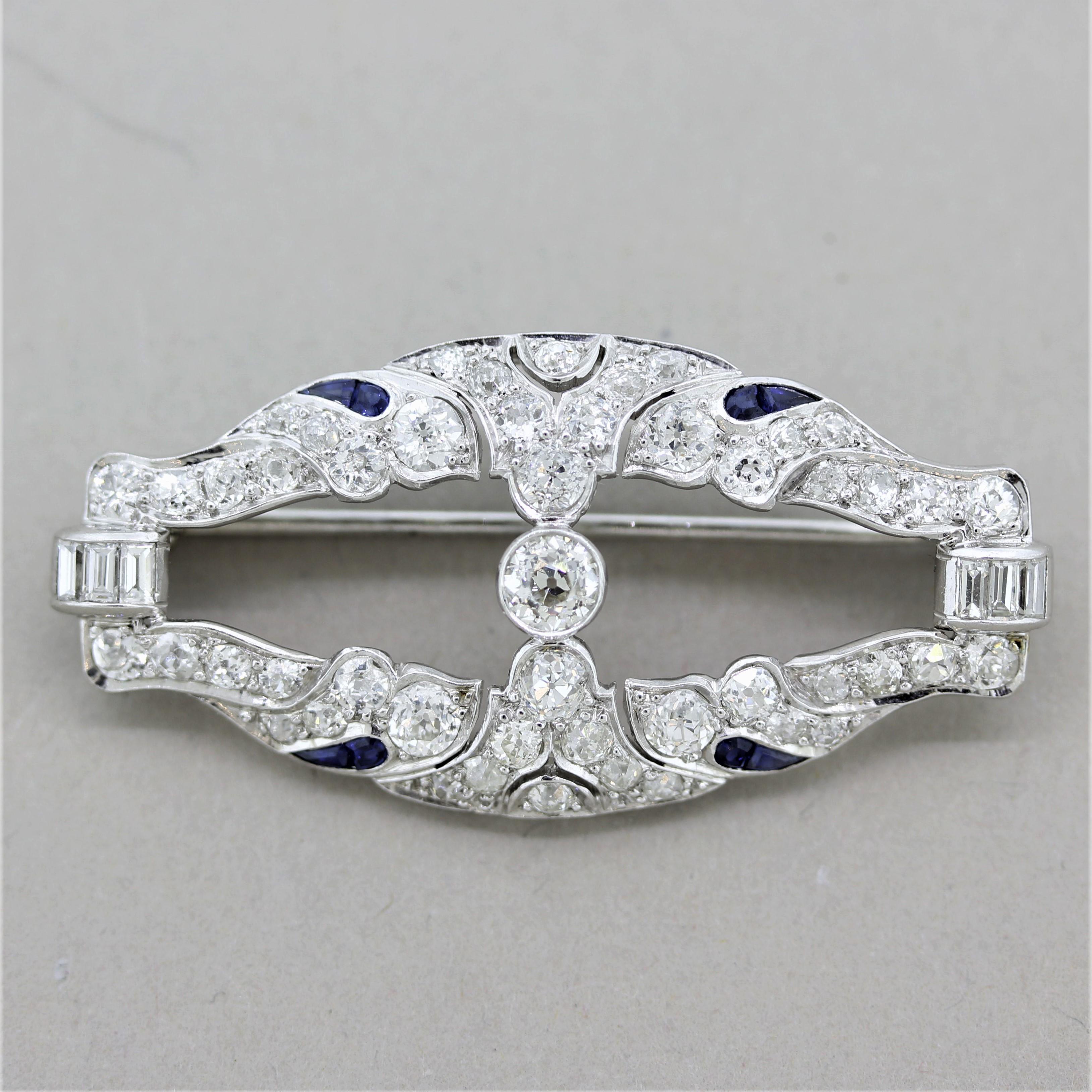 An original Art Deco antique, circa 1920’s, by Lambert Bros. The lovely brooch features approximately 3 carats of fine bright white European-cut diamonds along with blue sapphire accents. Hand-fabricated in platinum, a beautiful piece that will