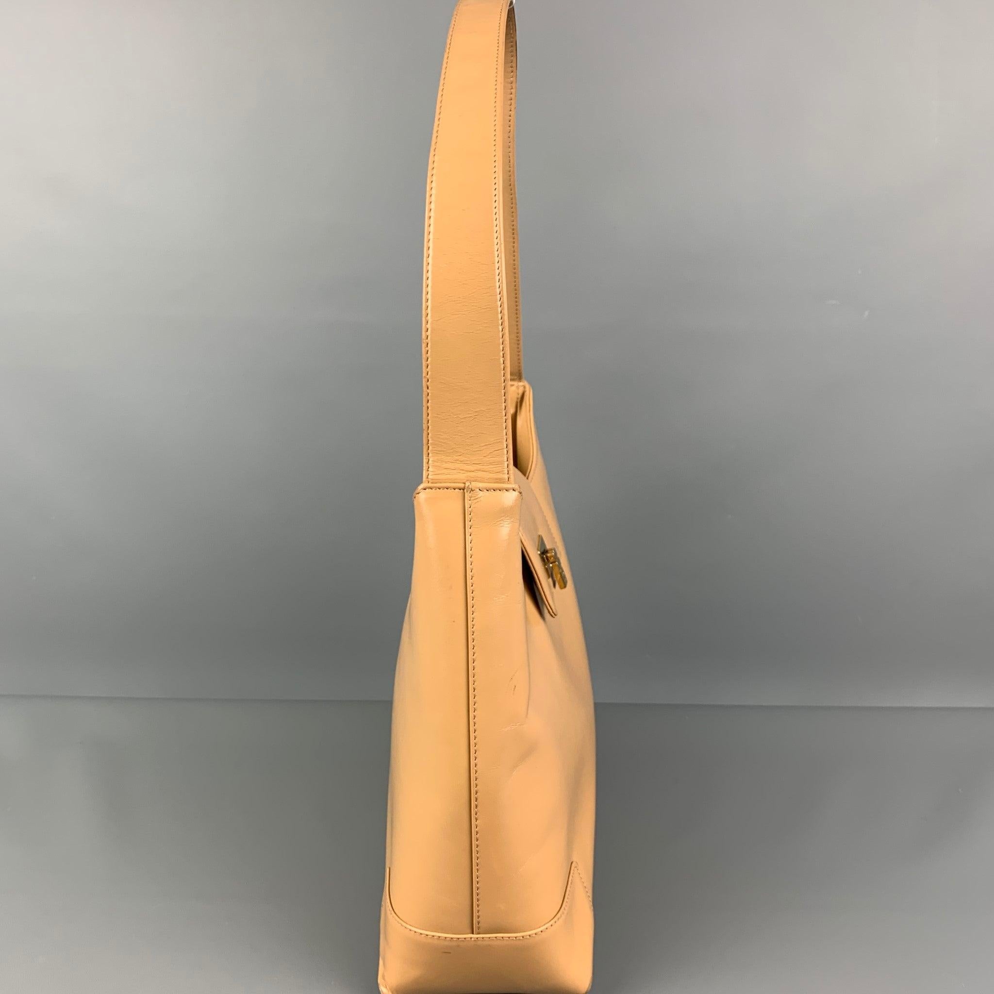 LAMBERTSON TRUEX handbag comes in a beige leather featuring a top handle, inner slots, and a gold tone clasp closure. Made in Italy.
Good
Pre-Owned Condition. Minor wear & marks. 

Measurements: 
  Length: 11 inches  Width: 3.5 inches  Height: 9