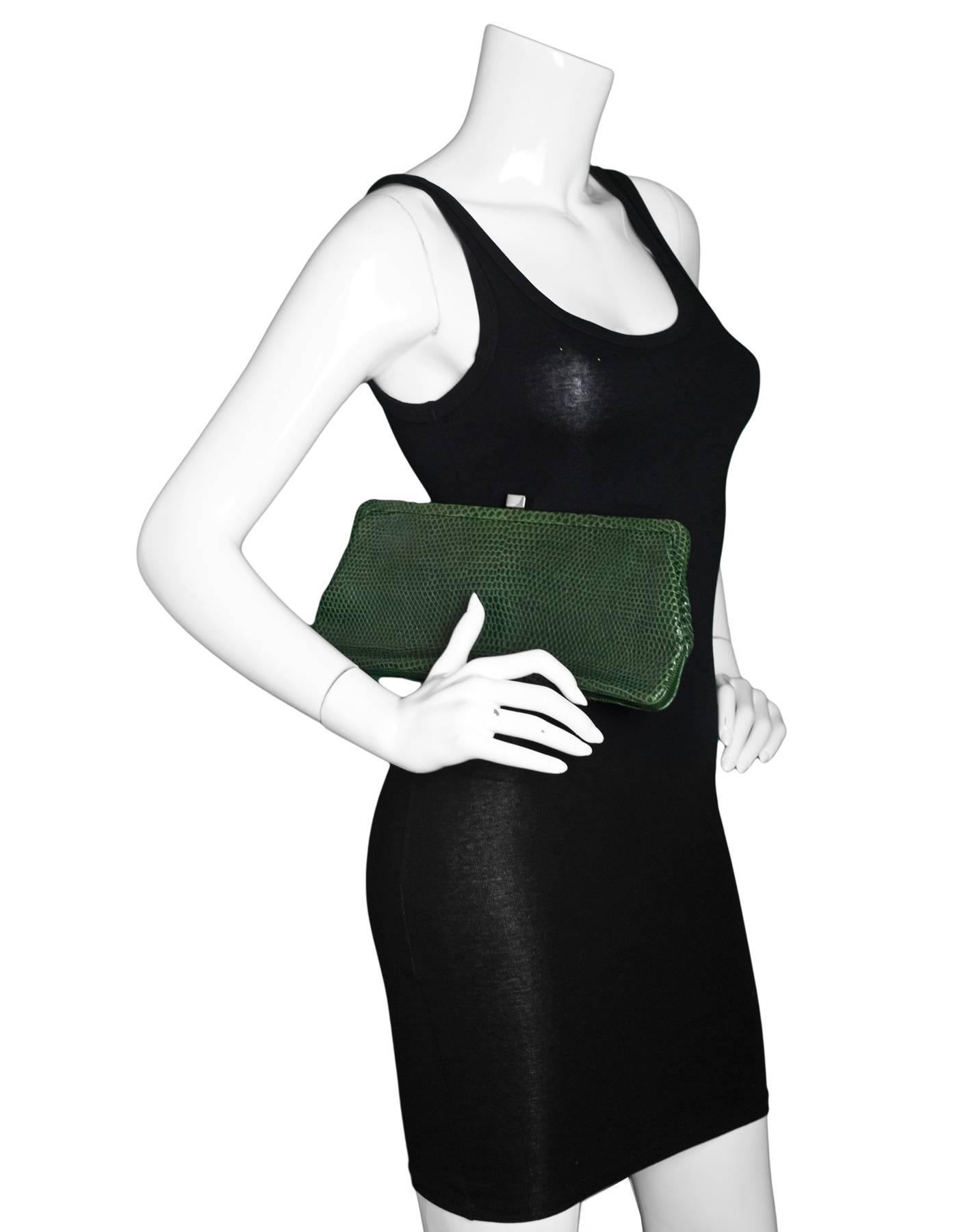 Lambertson Truex Green Lizard Clutch 

Made In: South Africa
Color: Green
Hardware: Silvertone
Materials: Lizard, metal
Lining: Blue textile
Closure/Opening: Frame top with snap closure
Exterior Pockets: None
Interior Pockets: One zip pocket
Retail