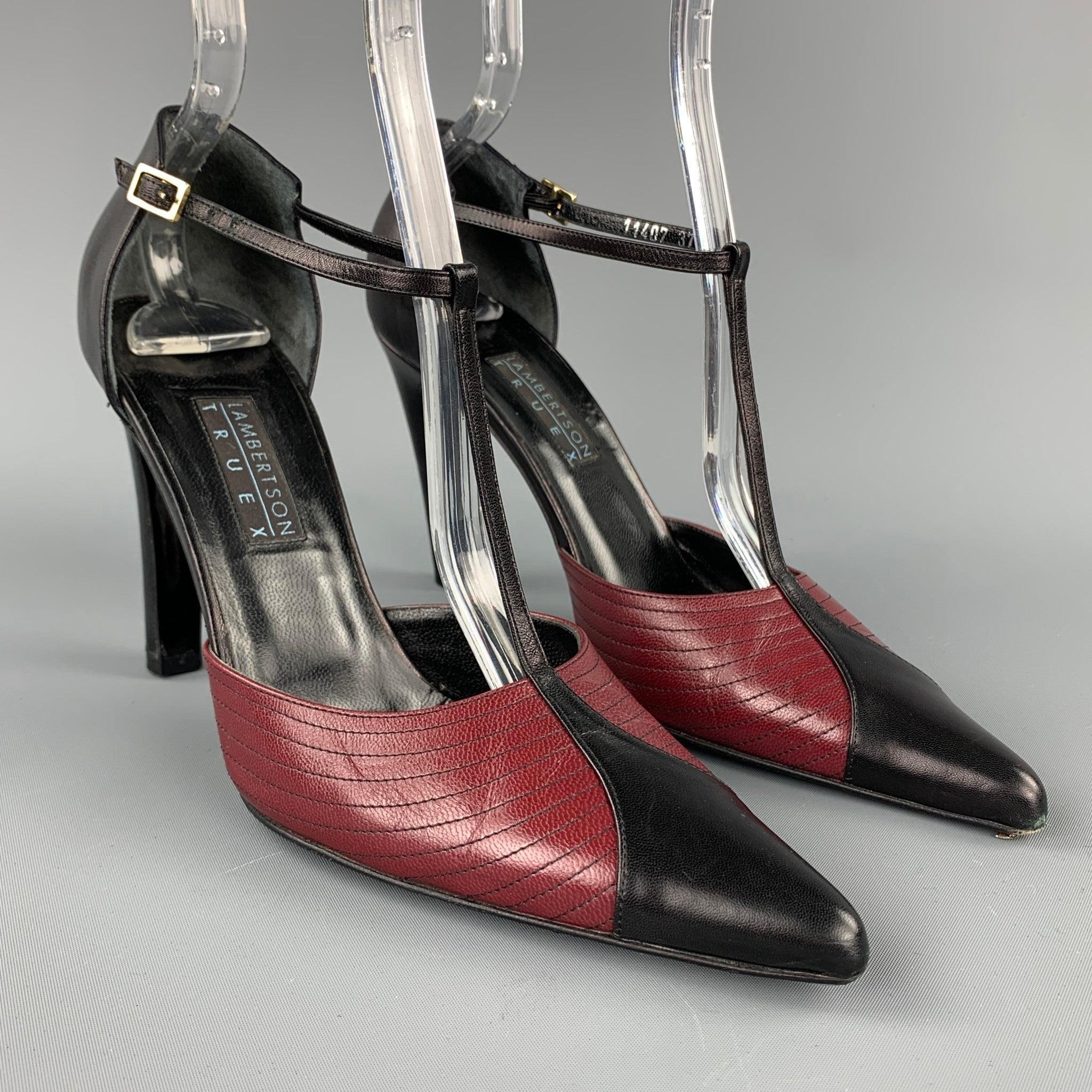 LAMBERTSON TRUEX pumps comes in black & red leather with top stitching featuring a t-strap, pointed toe, and a wooden heel. Made in Italy.Good
Pre-Owned Condition. 

Marked:   EU 37 

Measurements: 
  Heel:
4 inches  
  
  
 
Reference: