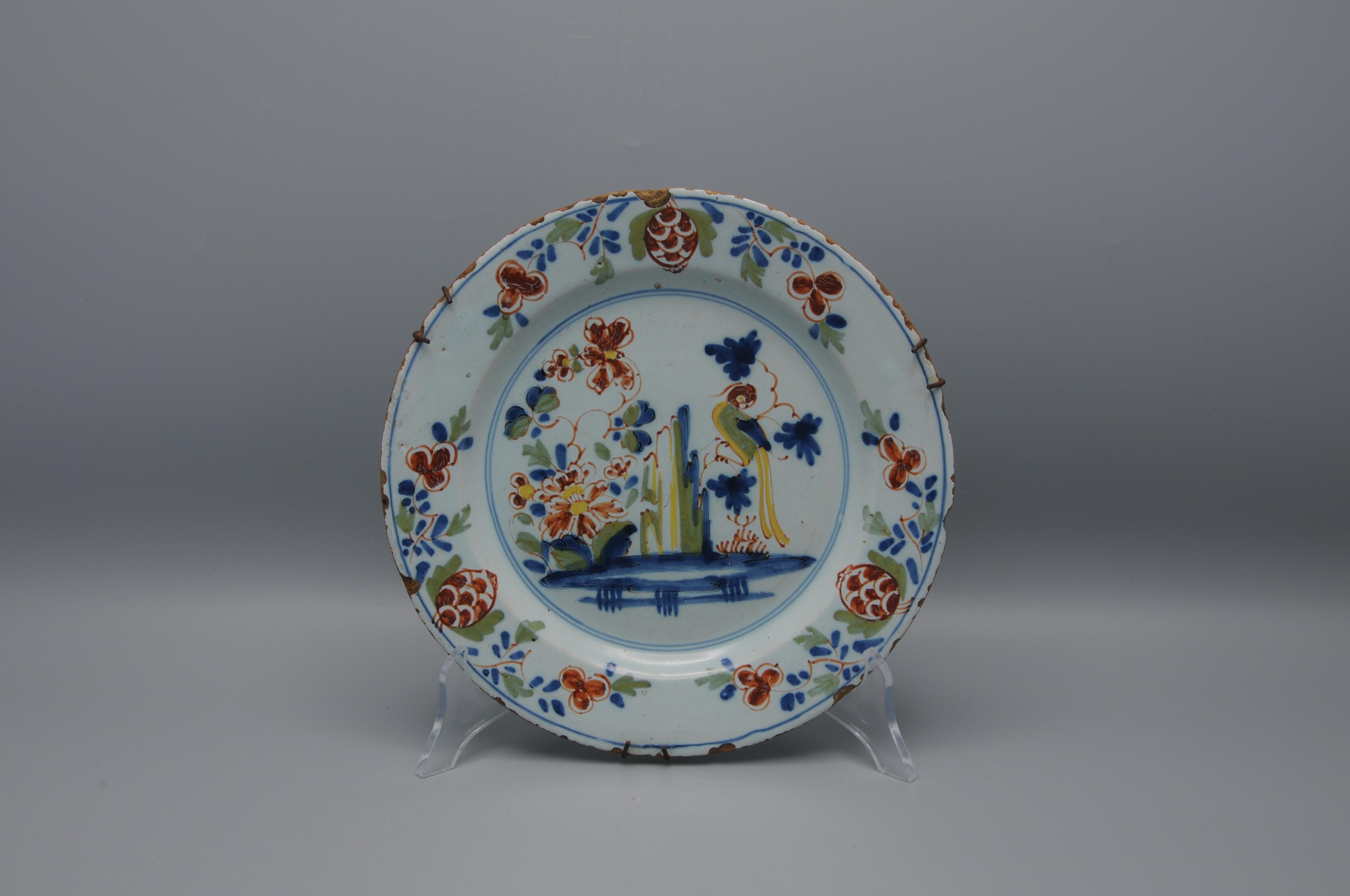 Motif bien-aimé du Delft anglais, le perroquet sur une branche dans un paysage de rochers et de fleurs. Ce motif particulier a été attribué à la poterie de Lambeth High Street d'Abigail Griffith. circa 1765-75. Peint en couleurs polychromes de