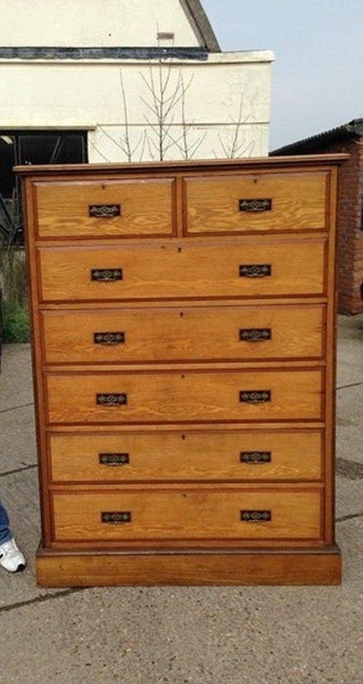 Lambs of Manchester, attributed.
A rare Aesthetic Movement, unusually tall chest of drawers made from ash each drawer with stylized brass drop handles and ebonized inlaid rectangular details behind the back plates. Handcut dove tails to the