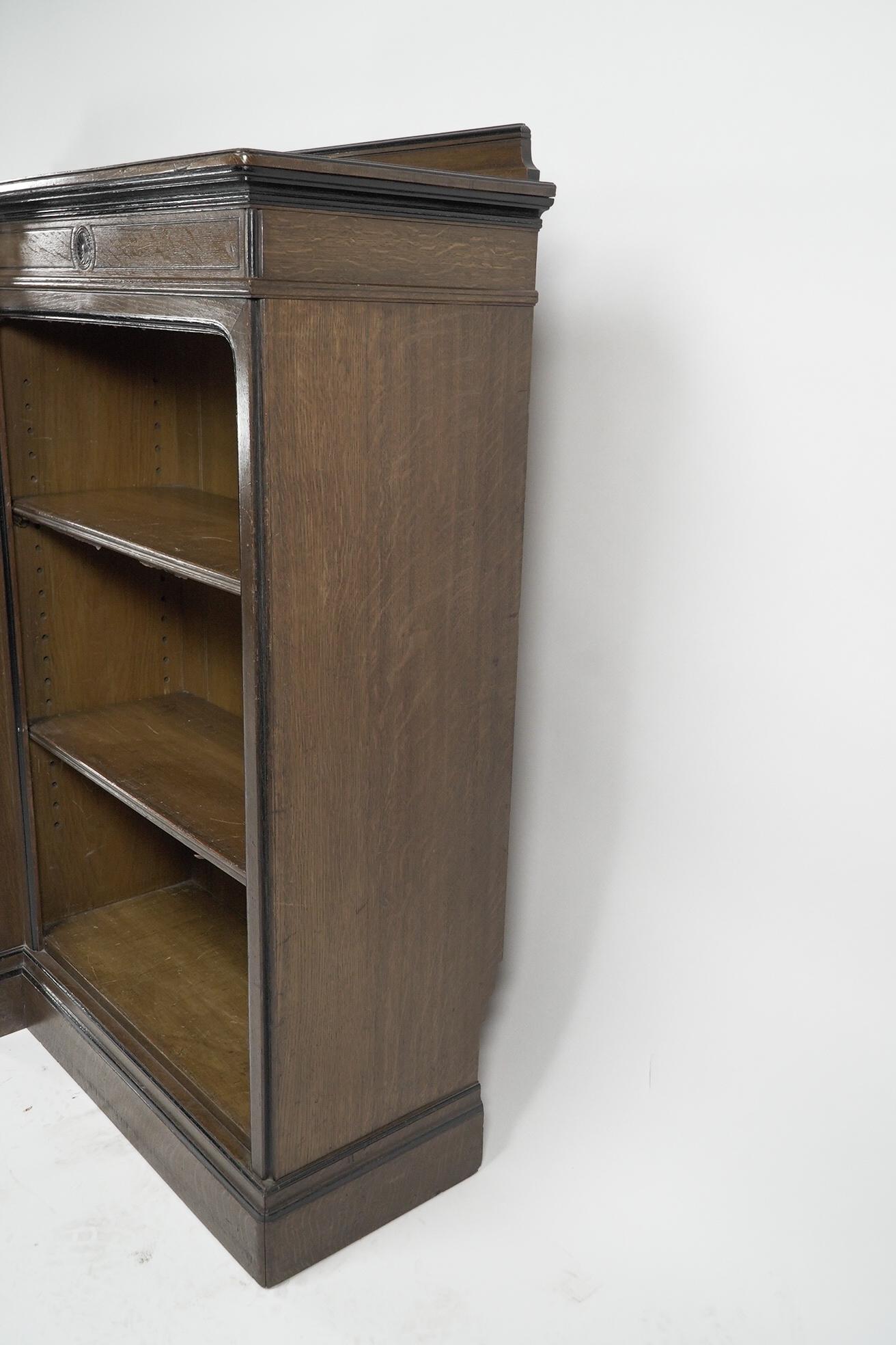 Late 19th Century Lambs of Manchester (stamped). A fine Aesthetic Movement oak breakfront bookcase For Sale