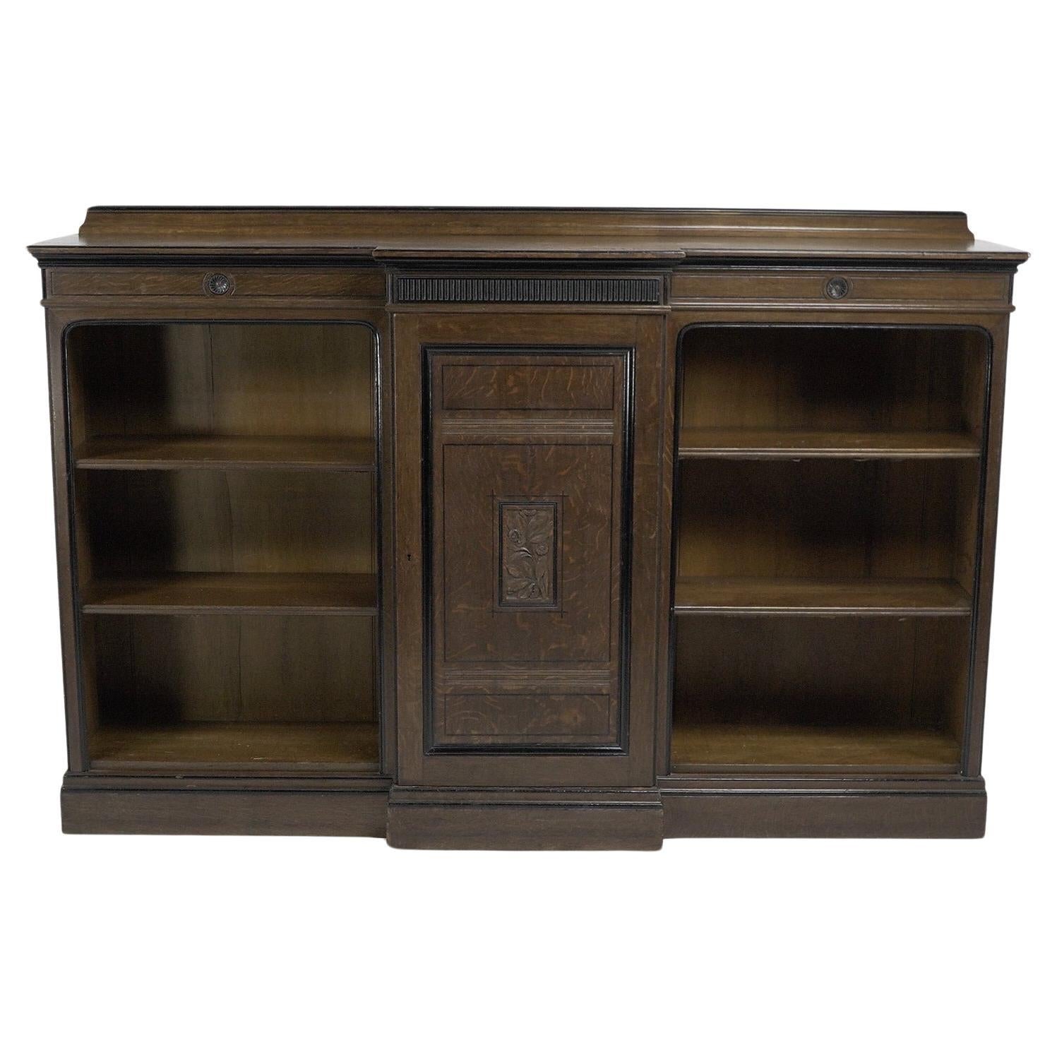 Lambs of Manchester (stamped). A fine Aesthetic Movement oak breakfront bookcase For Sale