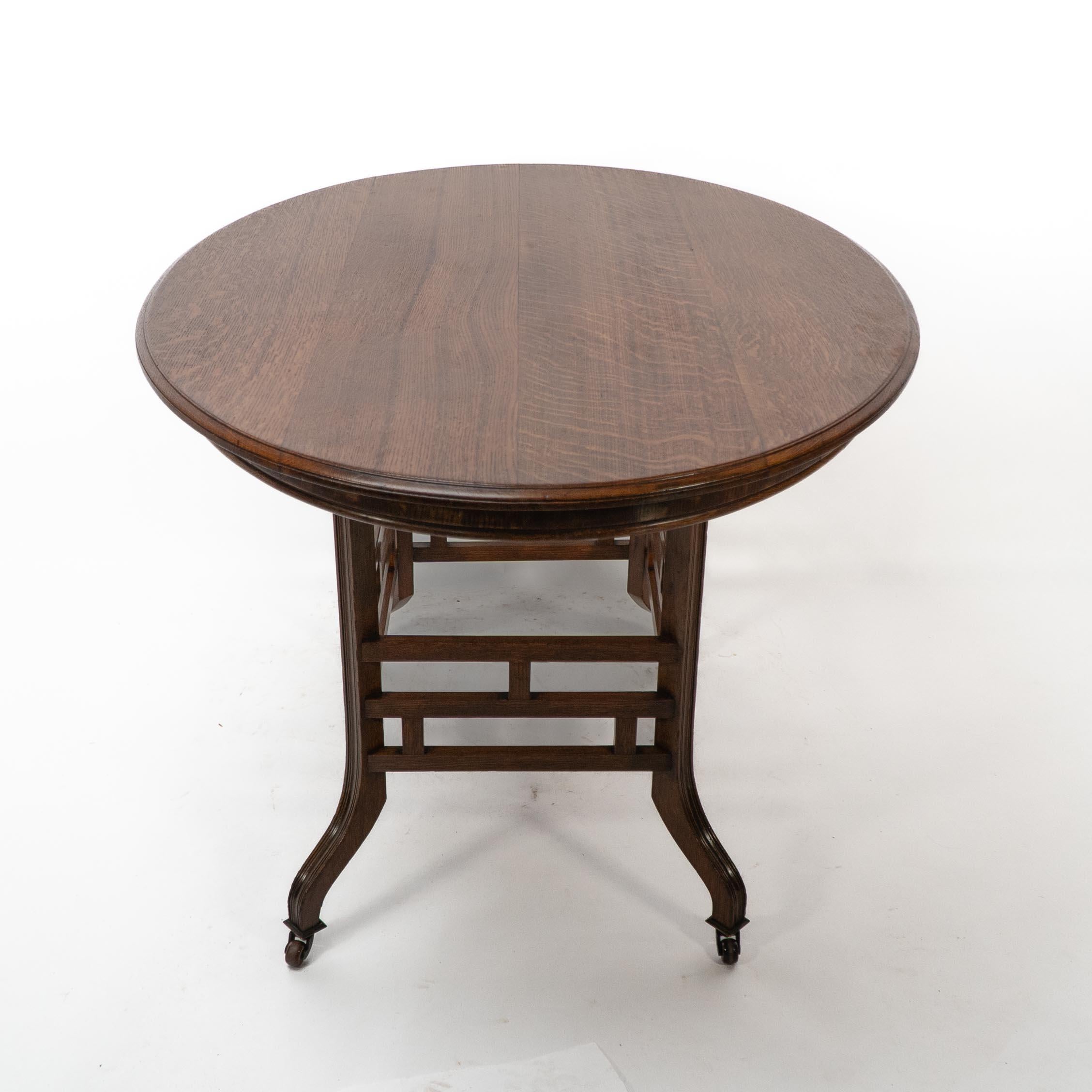 English Lambs of Manchester, stamped Lambs. A rare Anglo-Japanese oak oval centre table For Sale