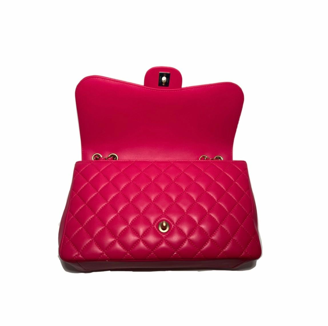 This is an authentic CHANEL Lambskin Quilted Medium Double Flap in Dark Pink. This stunning medium sized shoulder bag is crafted of diamond quilted lambskin leather in Dark Pink. It features threaded leather polished gold chain link shoulder straps