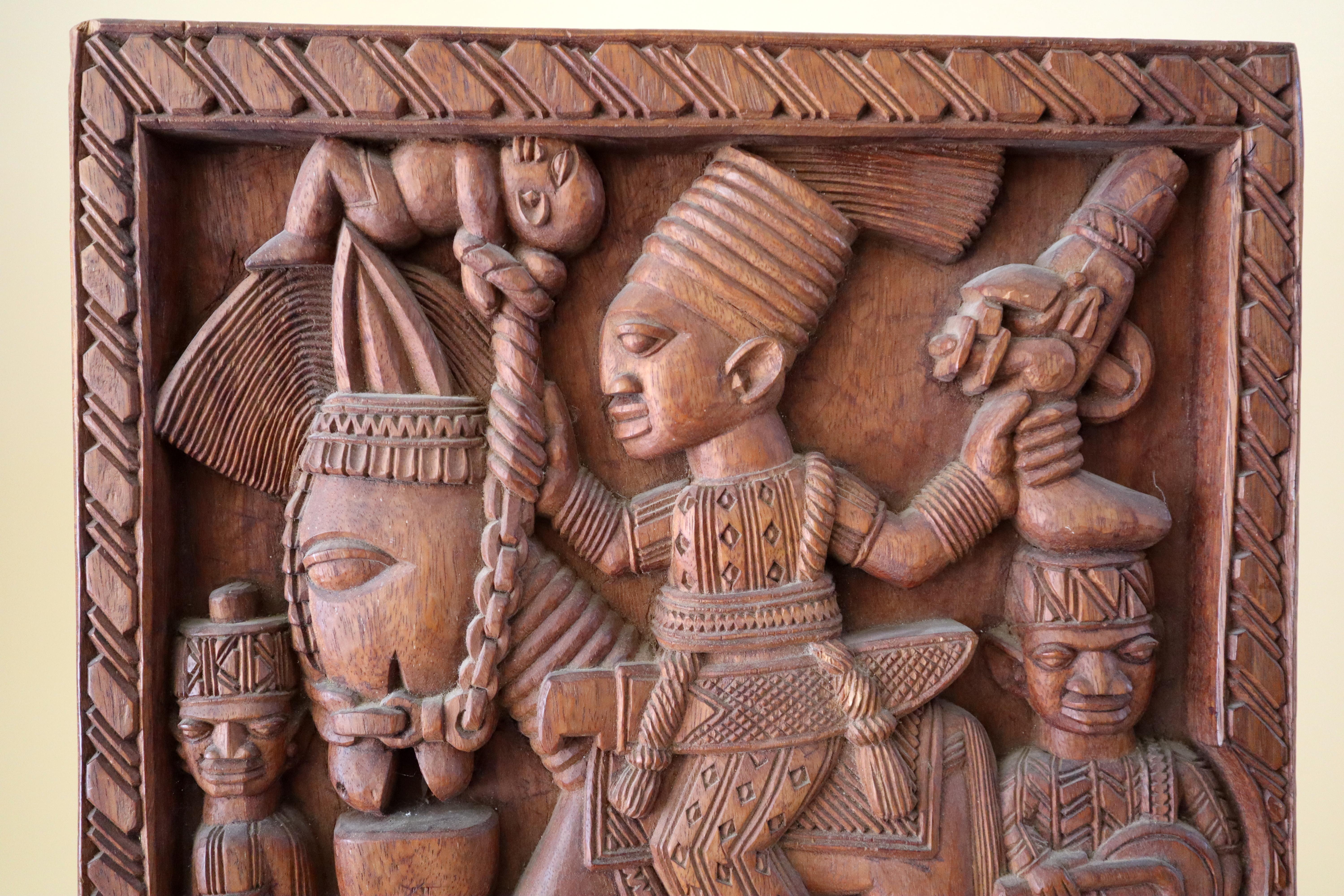 A deeply carved hardwood panel by the famous Nigerian sculptor Lamidi Olonade Fakeye, (1928-2009). Created in the 1960s. He boldly incised his name diagonally on the back upper right L. O. FAKEYE. A typewritten biography of the artist with some hand