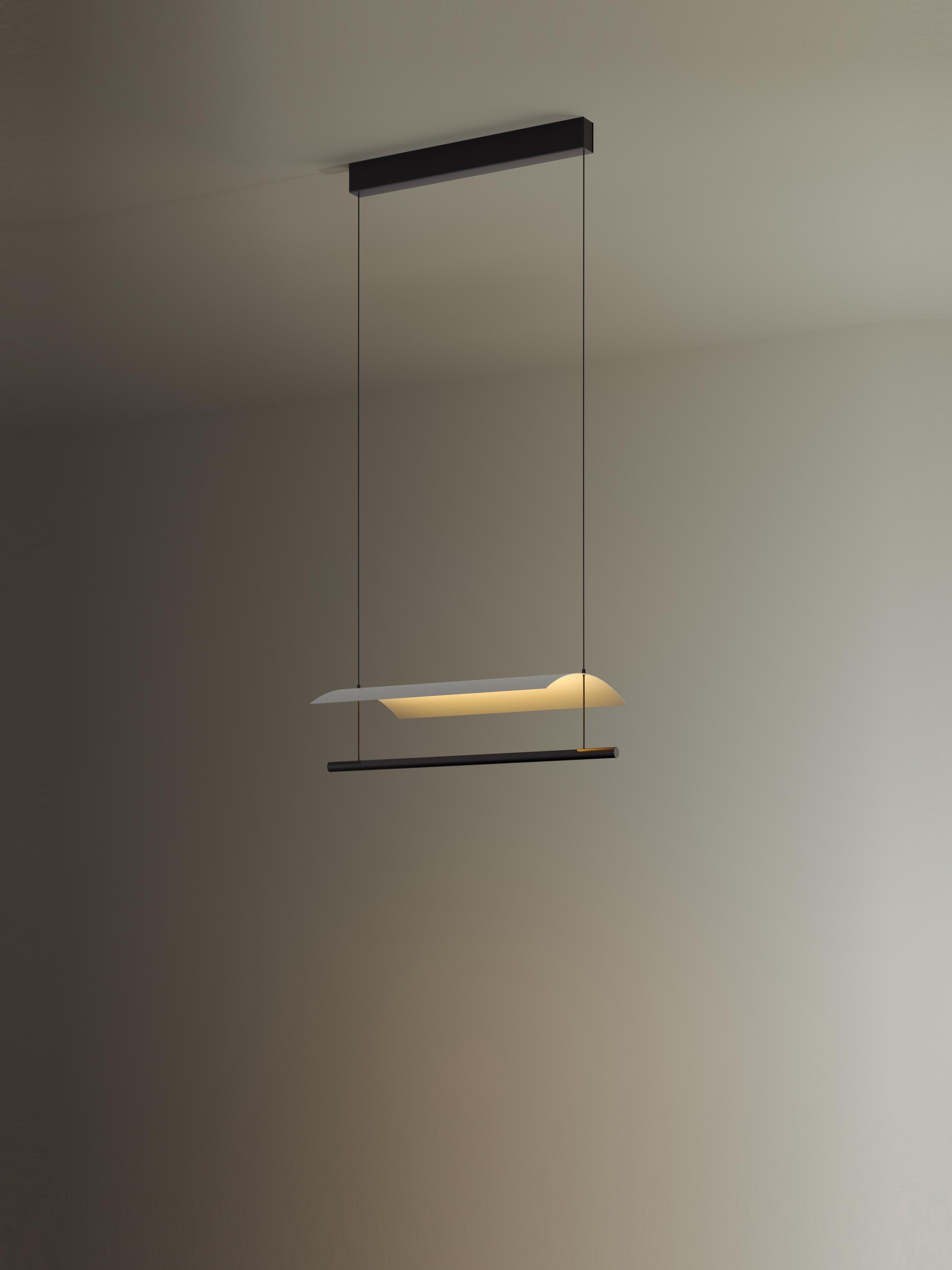 Lámina 45 pendant lamp by Antoni Arola
Dimensions: D 58.7 x W 30 x H 12.6 cm
Materials: Metal, plastic.
Available in other sizes.

A line of light and a thin metal sheet create a soft but effective levity. A marriage of the poetic and the