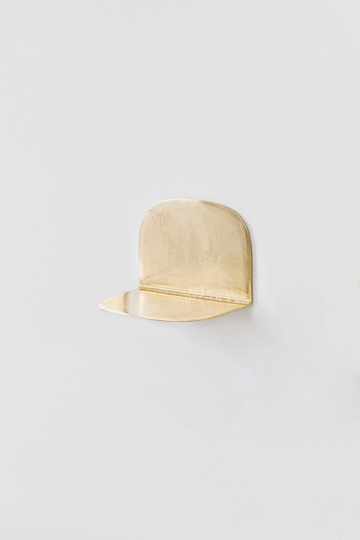 “Lâmina” (2025) designed by Lucas Recchia is a series of six individual small shelves, each with its own unique form and proportion, cast in unpolished bronze. The pieces highlight Recchia’s refined exploration of material tactility and minimalist