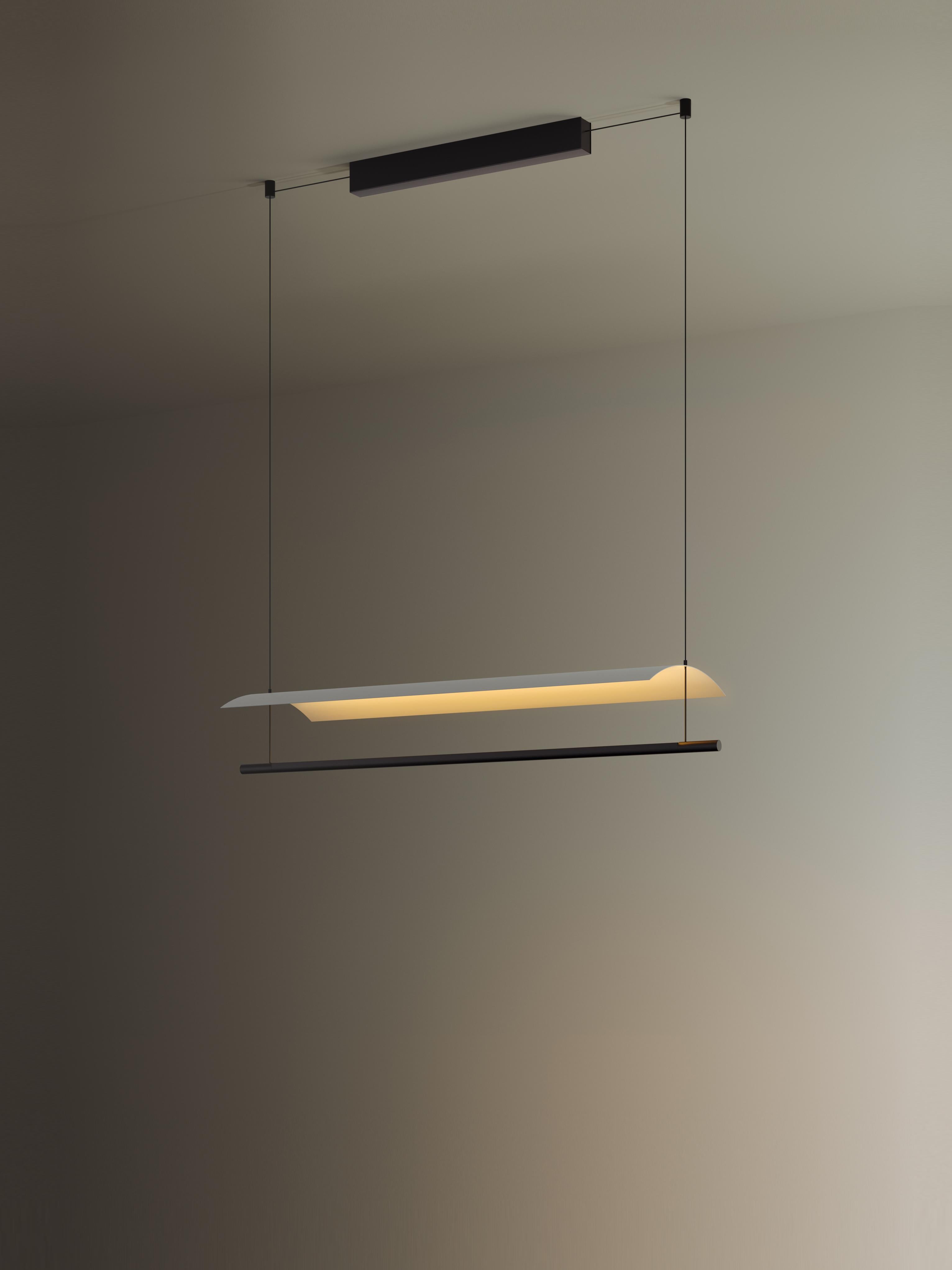Lámina 85 pendant lamp by Antoni Arola
Dimensions: D 98.7 x W 30 x H 12.6 cm
Materials: Metal, plastic.
Available in other sizes.

A line of light and a thin metal sheet create a soft but effective levity. A marriage of the poetic and the