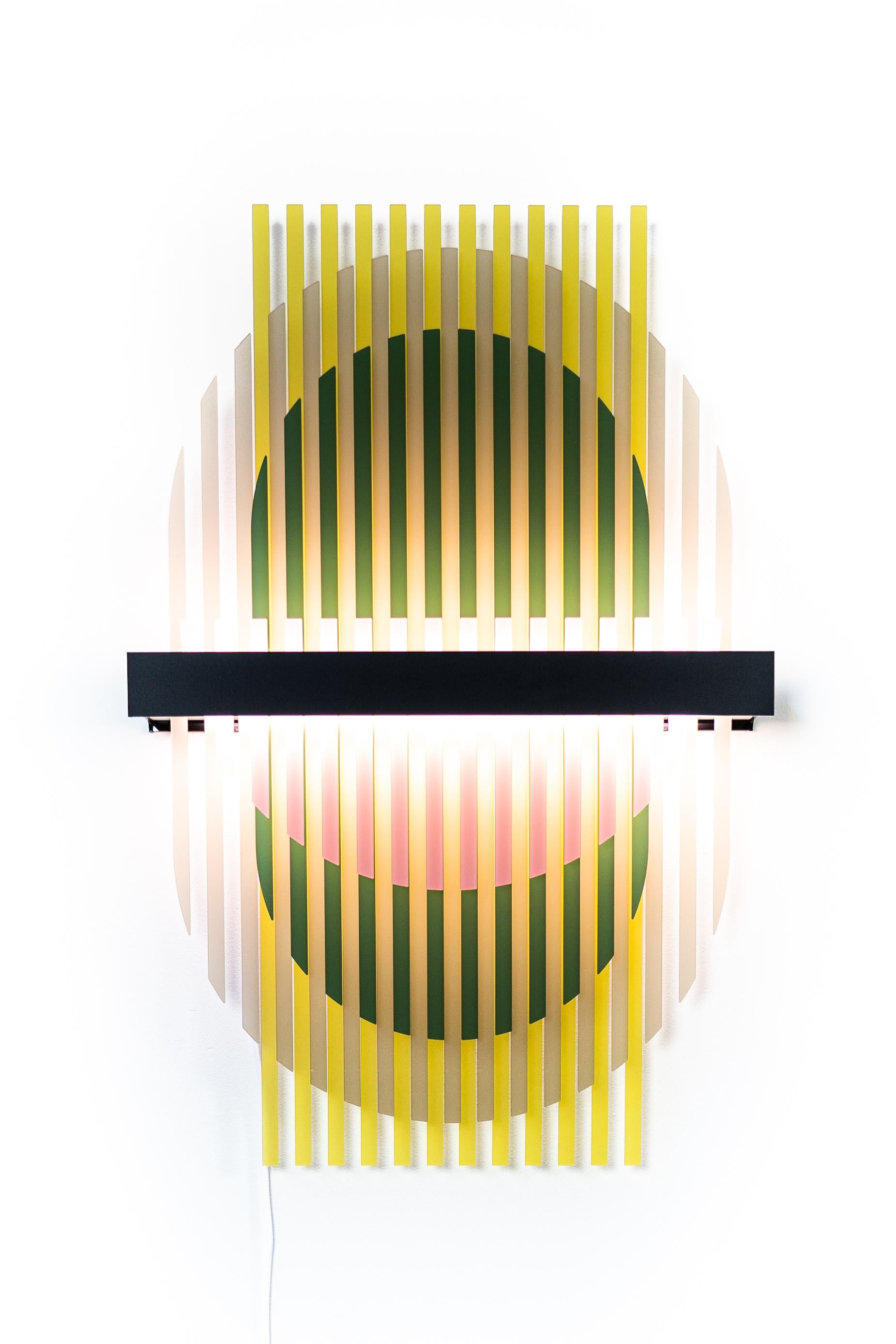 The new lamina light sculptures reveal a unique experience through distributing light between layered structures. The light sculpture creates fluctuating color patterns within its transparent slats. Various patterns are available for one light