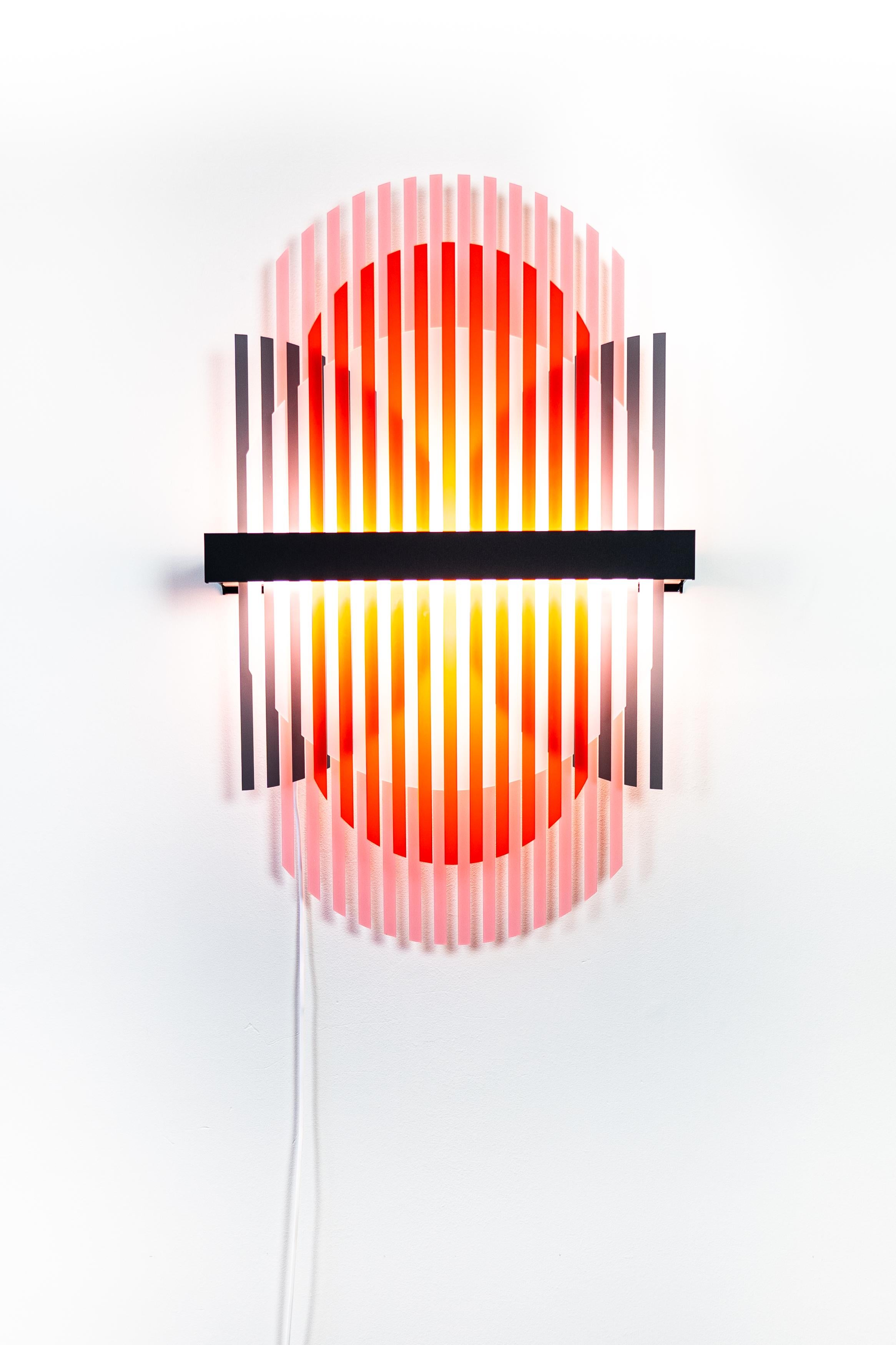 The new Lamina Light sculptures reveal a unique experience through distributing light between layered structures. The light sculpture creates fluctuating color patterns within its transparent slats. Various patterns are available for one light