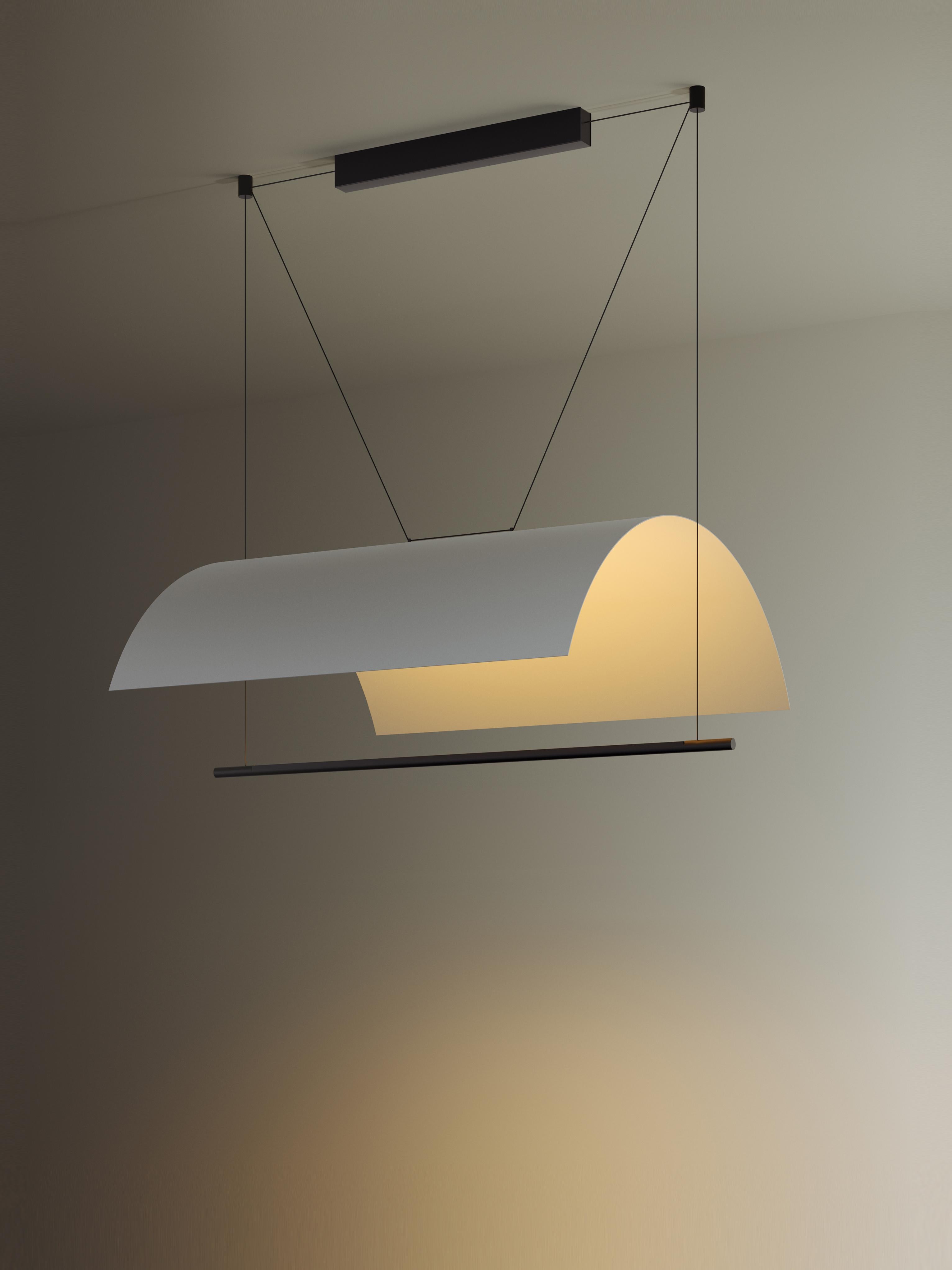 Lámina Mayor pendant lamp by Antoni Arola.
Dimensions: D 98.7 x W 80 x H 35 cm.
Materials: Metal, plastic.

A line of light and a thin metal sheet create a soft but effective levity. A marriage of the poetic and the practical, Lámina is a system