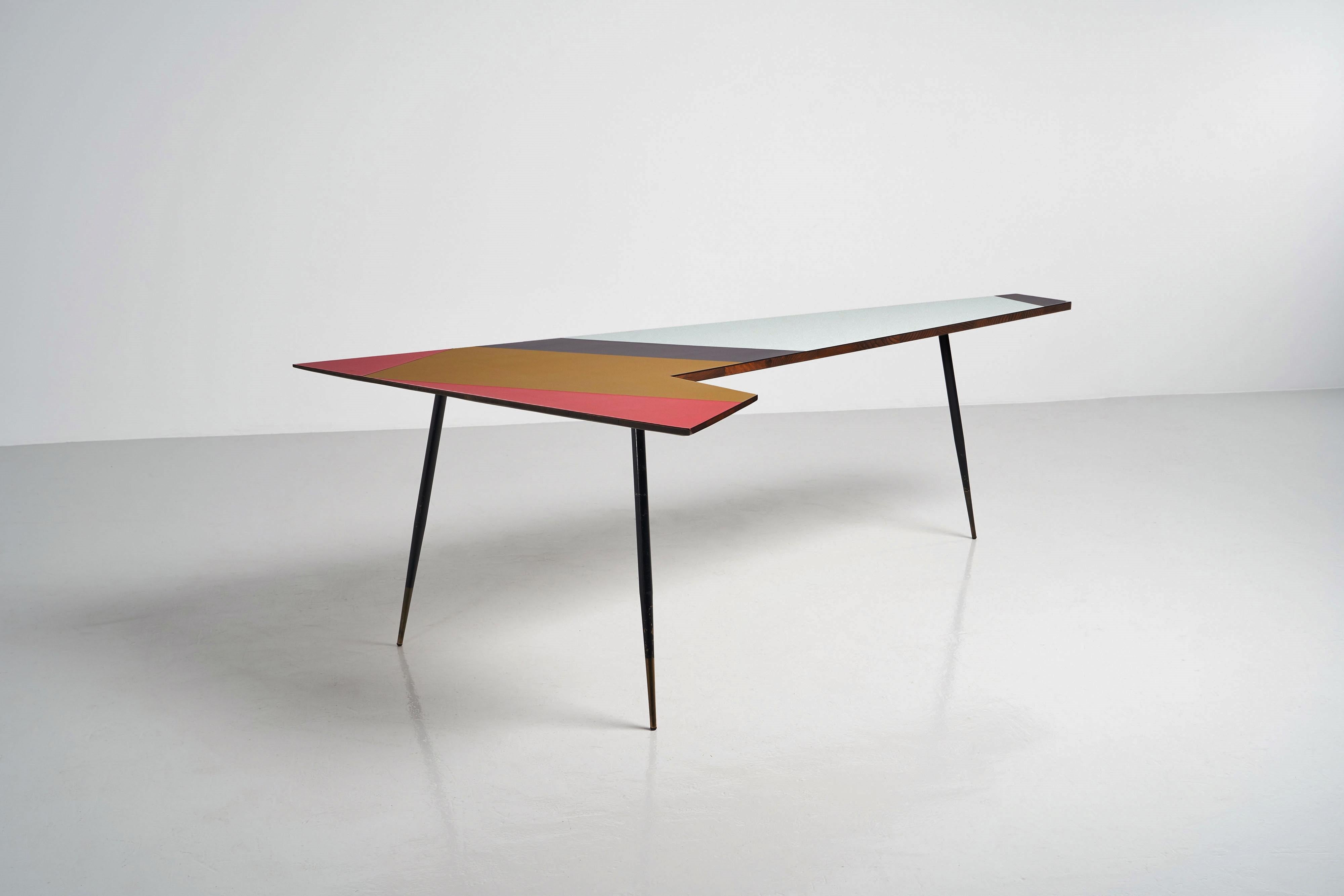 Step back into the iconic Italian style of the 1950s with this Ponti-inspired asymmetrical boomerang desk. The desk’s plywood top features a high gloss laminated finish with coloured abstract shapes in shades of red, gold, anthracite and light blue,