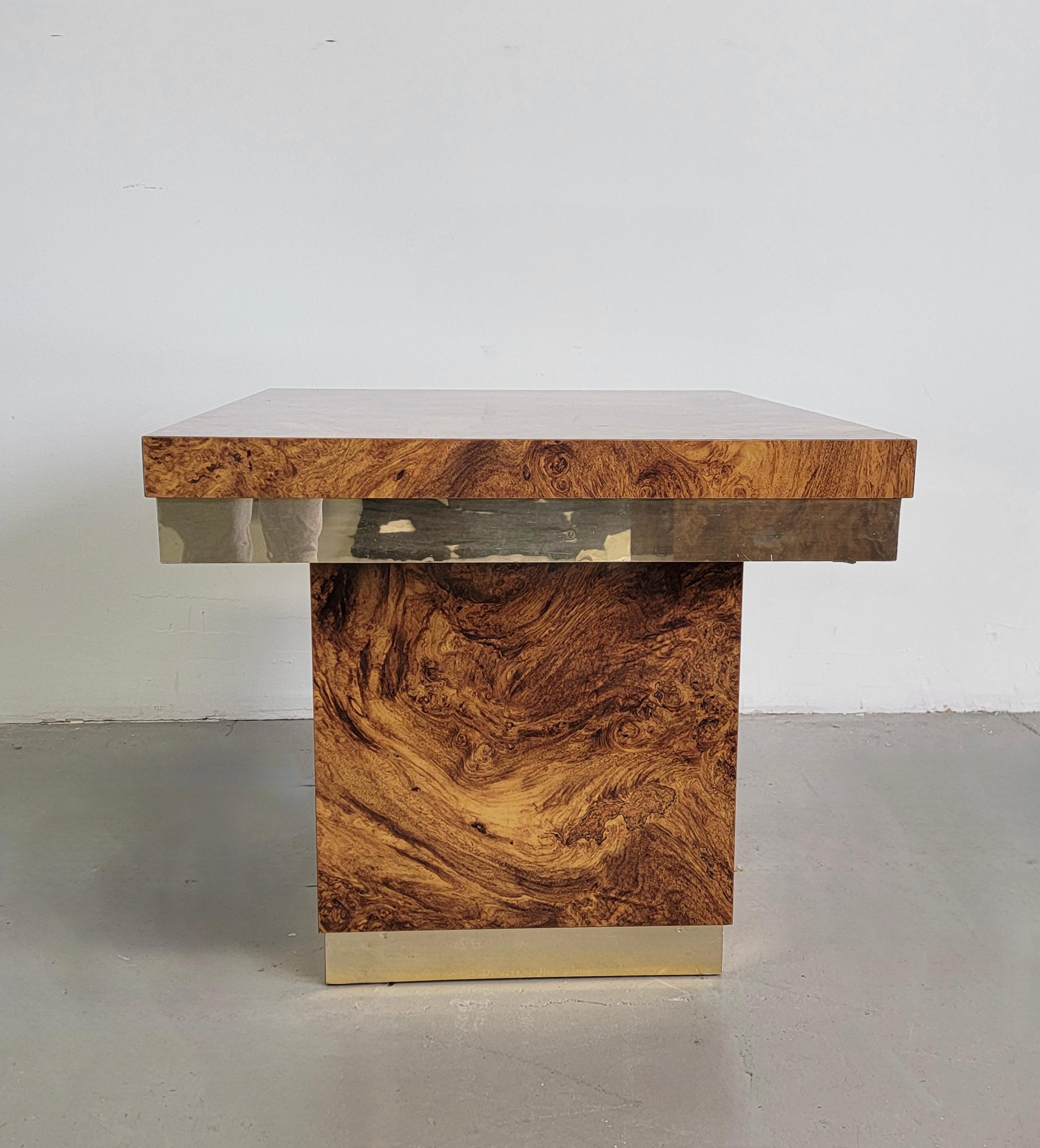 Gorgeous laminated 'burlwood' table with brass detailing. This lovely piece can be used as am end or side table. It was made in the 1970s and similar to the style of Milo Baughman. Its laminated with the look of burlwood which makes it ideal for