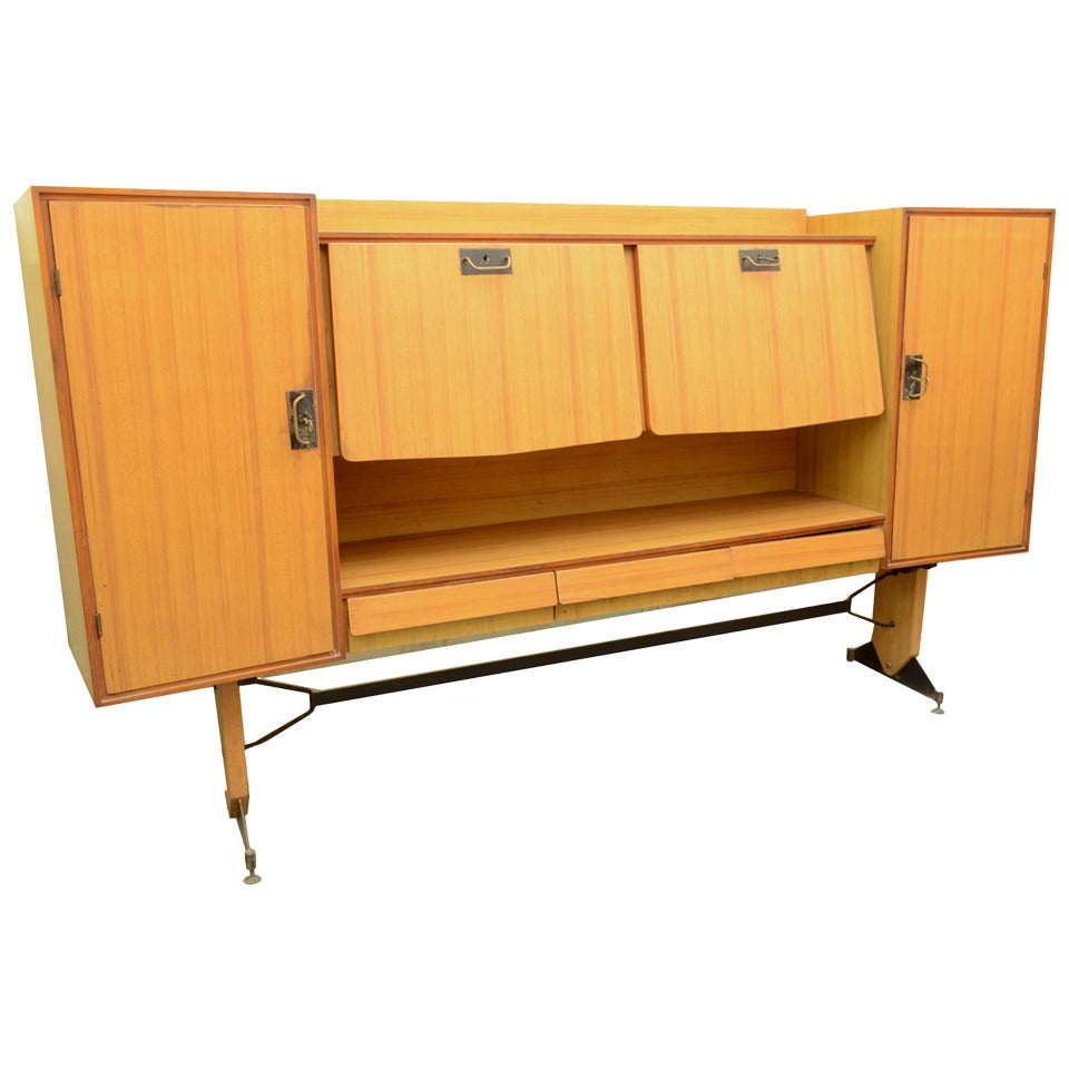 Italian sideboard signed Brevetti Porzi Lissone, 1948, in laminated wood with fine brass locks, satin finished black metal legs and brass feet adjustable in height.
Measures: Width cm 234 - inches 92.12, height cm 133 - inches 52.36, depth cm 44 -