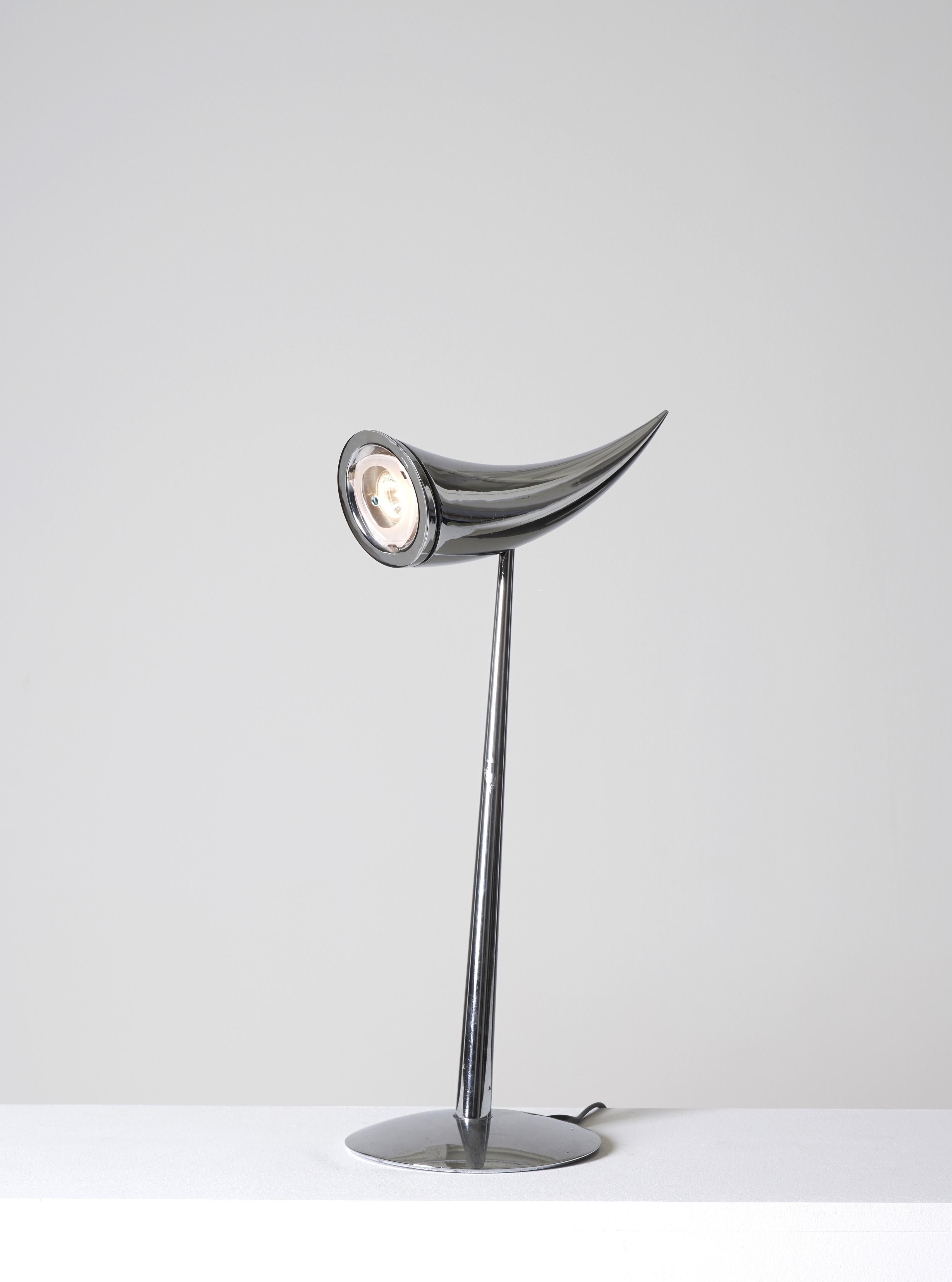 Sublime Ara Lamp designed by Philippe Starck for Flos in 1988. Dynamic and sculptural line in polished chrome. The lamp also swivels to direct the light towards a desk task or bedside reading.