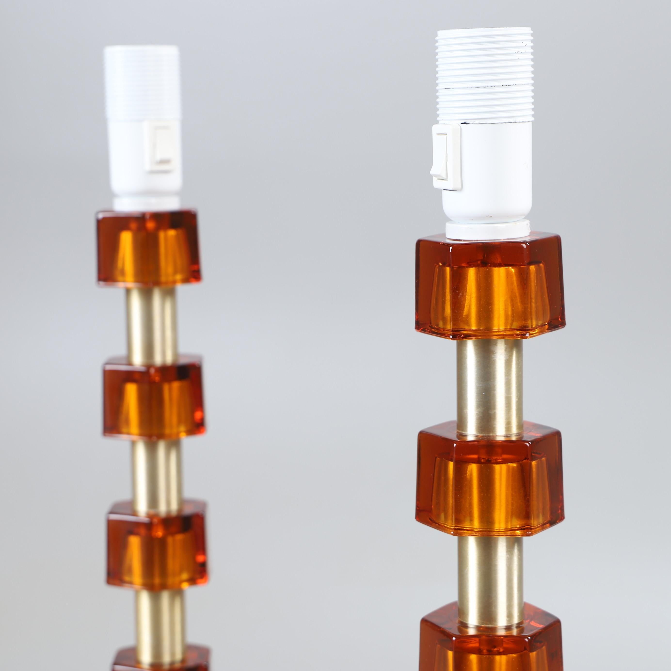 Rare tall lamp from Sweden 1960s cast glass amber color and brass. Manufactured in Sweden 1960 by Nybro Armaturfabrik 
Good condition
 2 lamp available price for 1