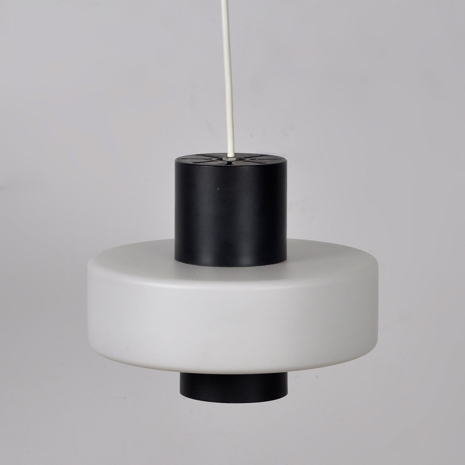 Hanging lamp from the Raak brand, produced in the 1960s. Made of metal and opal glass.