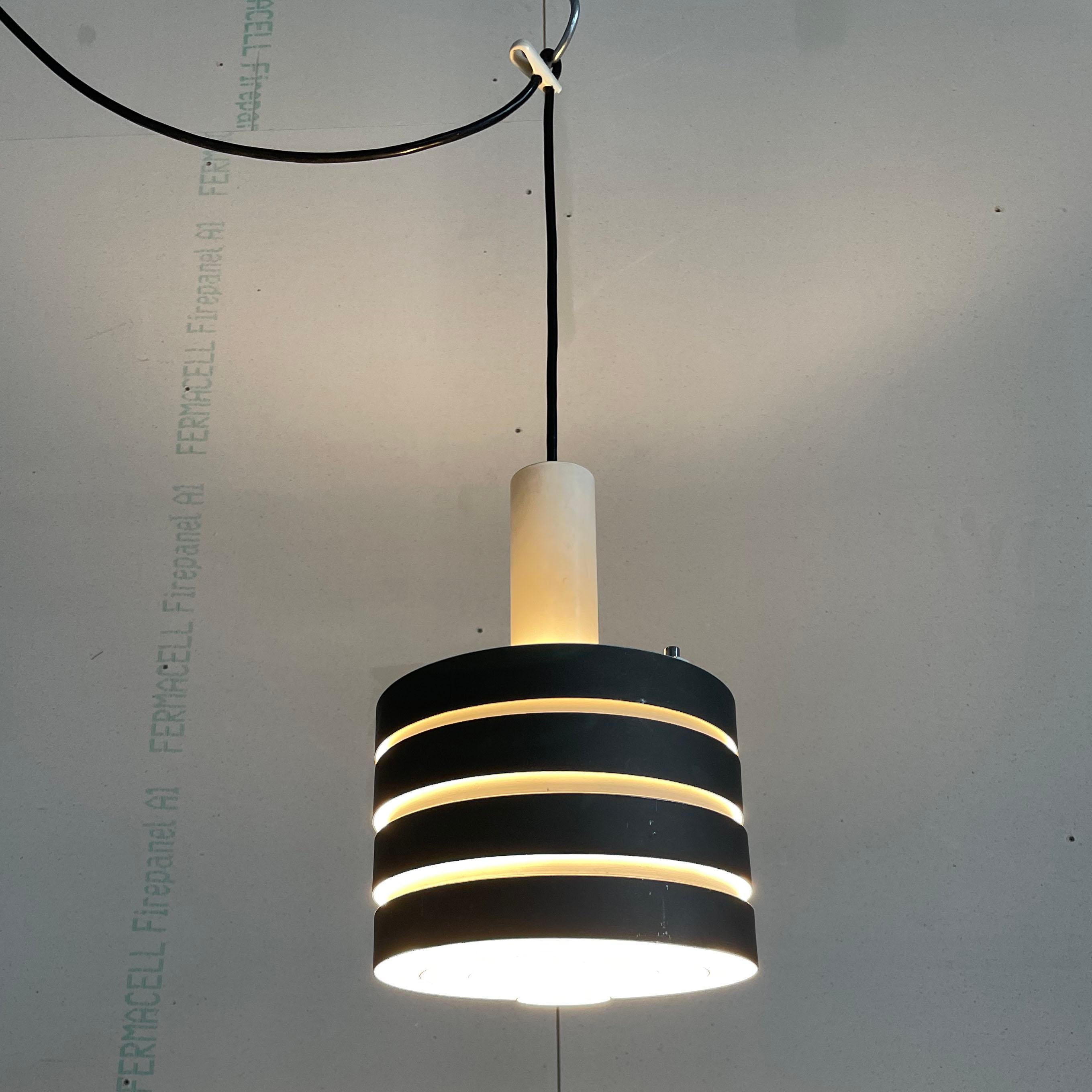 Vintage 1960’s Metal Pendant Lamp. In the style of Jo Hammerborg. 
Origin unknown.
Measurements: Diameter: 20 cm  Height: 30 cm 
Colour: Grey / White (the grey appears to have been added at a later date)
Condition: Very good with signs of use