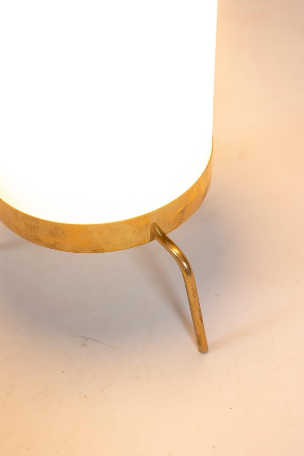 Lamp in white opaline and golden brass, circular and tube-shaped. Tripod shaped base.

Italian work realized in the 1970s.
