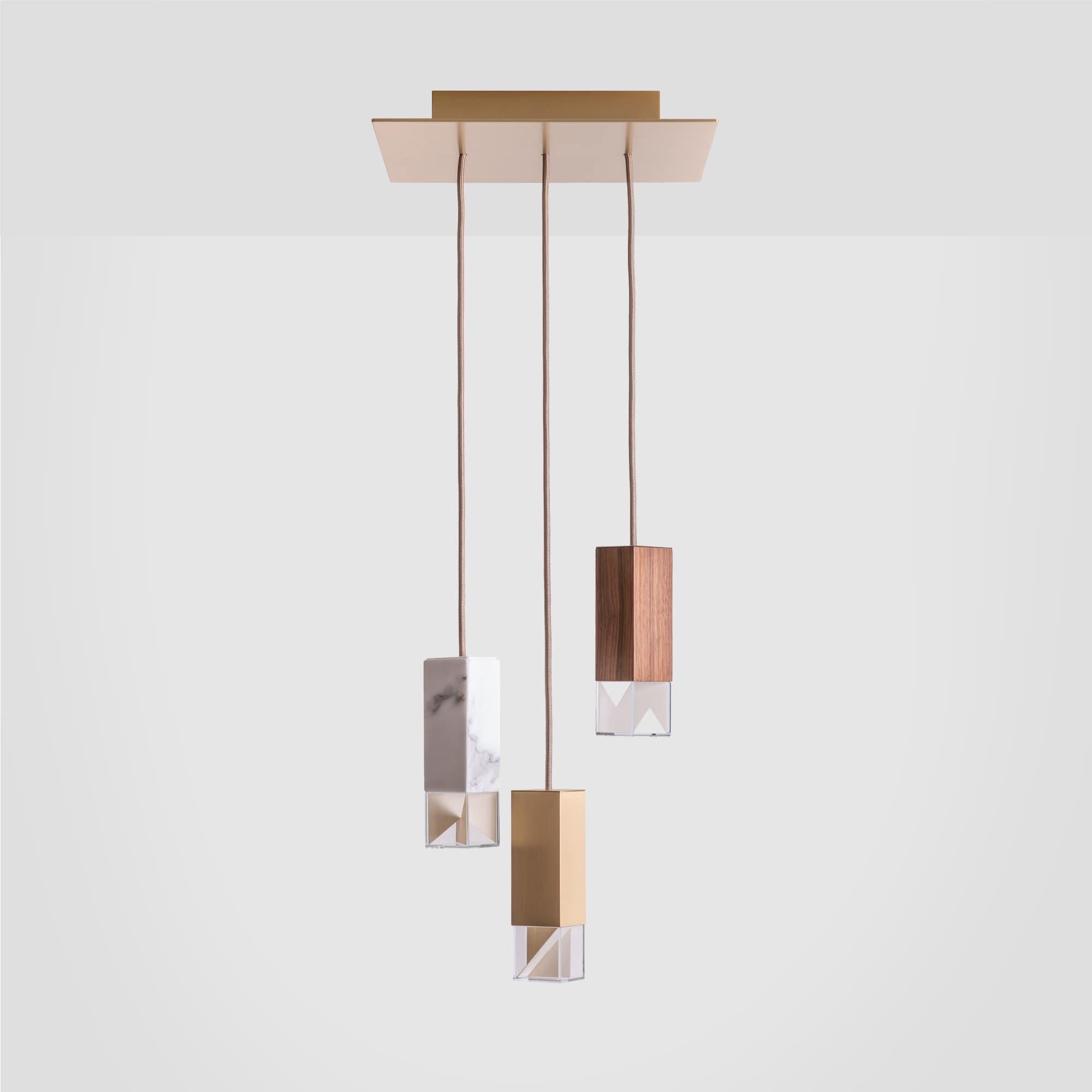 Lamp One collection chandelier by Formaminima
Dimensions: 30 x 30 x H 68 cm
Materials: Lamp bodies available in Calacatta marble, satin solid brass, walnut solid
wood.
Ultra-thin anti-reflection crystal diffuser.
Inside-diffuser Limoges
