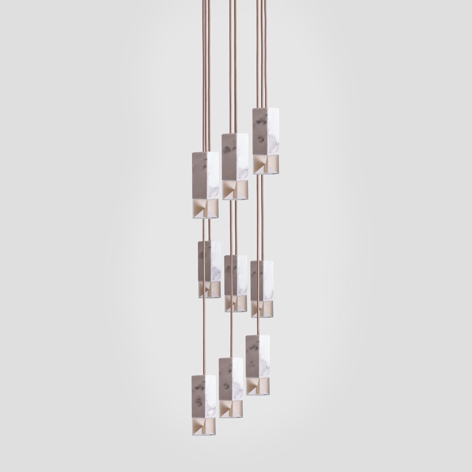 Inspired by midcentury designs, this superb chandelier is a statement piece that will add an elegant accent in a high-ceiling dining room or foyer. This piece showcases an architectural Silhouette composed of nine rectangular shades suspended at