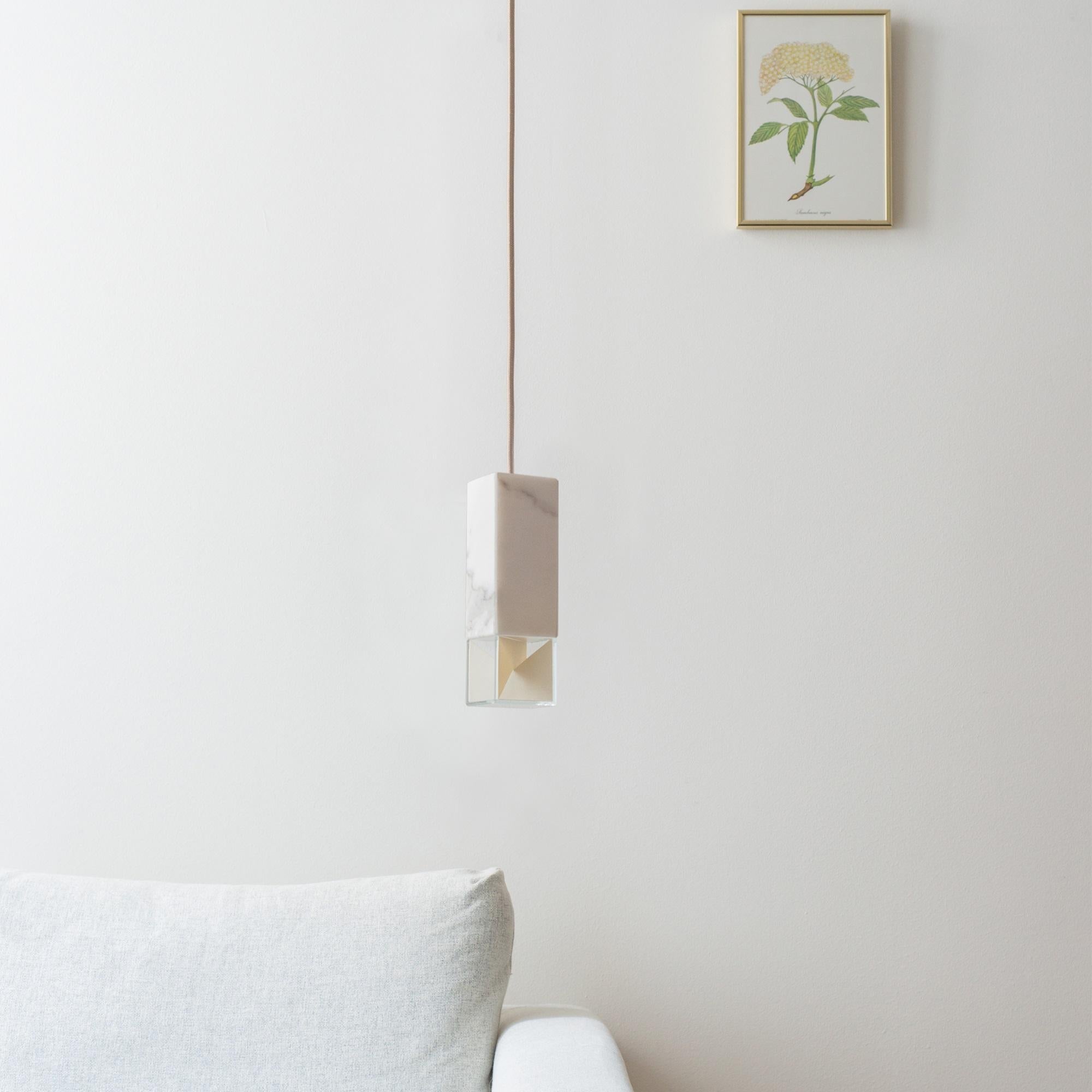 Elegant and Minimalist, this pendant lamp boasts a timeless design that will look stunning alone or with the others from the lamp/One Collection to create an eclectic display in any interior. Handcrafted of white Calacatta marble, the rectangular