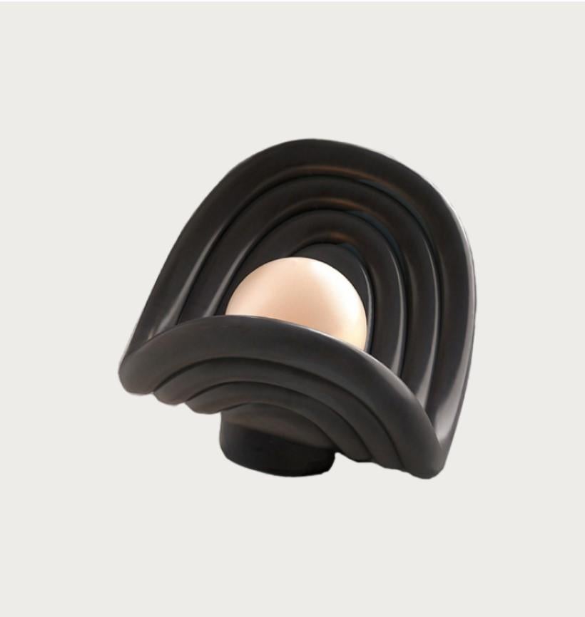 Sculpture table lamp made from natural stone or natural wood.