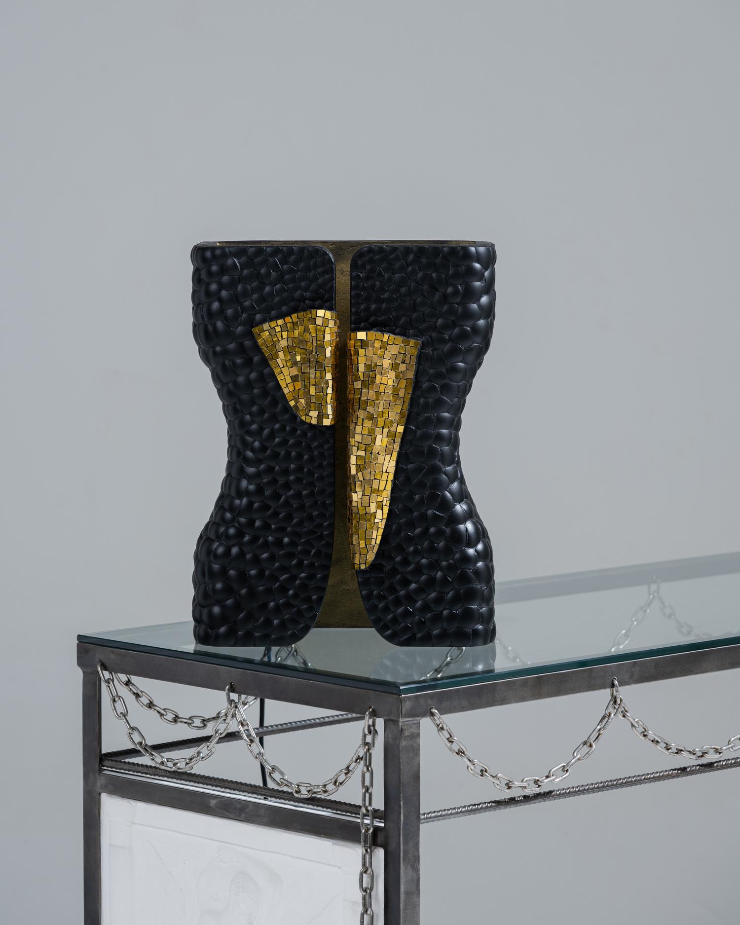 Table lamp from the Smok collection by Studio Karen B, created in collaboration with Atelier Nathalie Chaulaic. Its silhouette, inspired by the feminine tuxedo imagined by Yves Saint Laurent, is adorned with mosaic tesserae in golden glass paste and