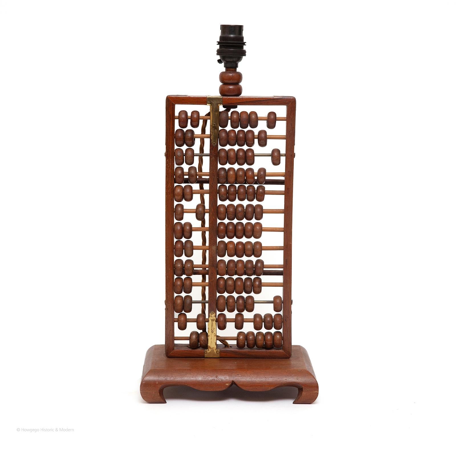 CHINESE, HARDWOOD, ABACUS OR SUANPAN WITH 13 RODS, TWO HEAVEN BEADS & FIVE EARTH BEADS UPCYCLED INTO A TABLE LAMP, 16½“ HIGH

Fun and engaging, interactive table lamp that can also be used as calculating tool
As well as providing light, this table