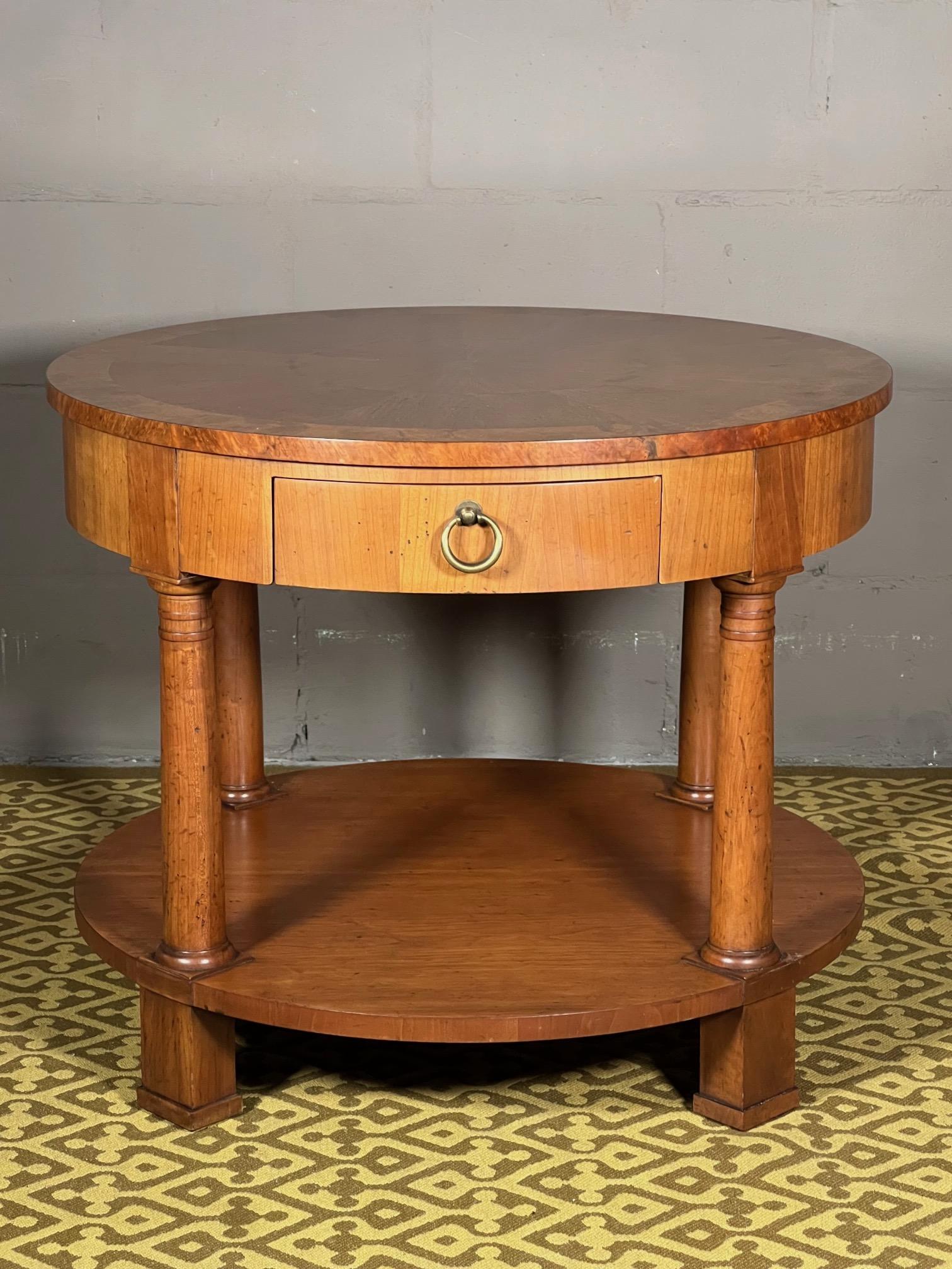 A beautiful Empire style cherry and walnut side or lamp table by Baker furniture. Ca' 1970's, solid brass hardware, pull out drawer. Heavy and very well made. Featuring a sunburst pattern top.