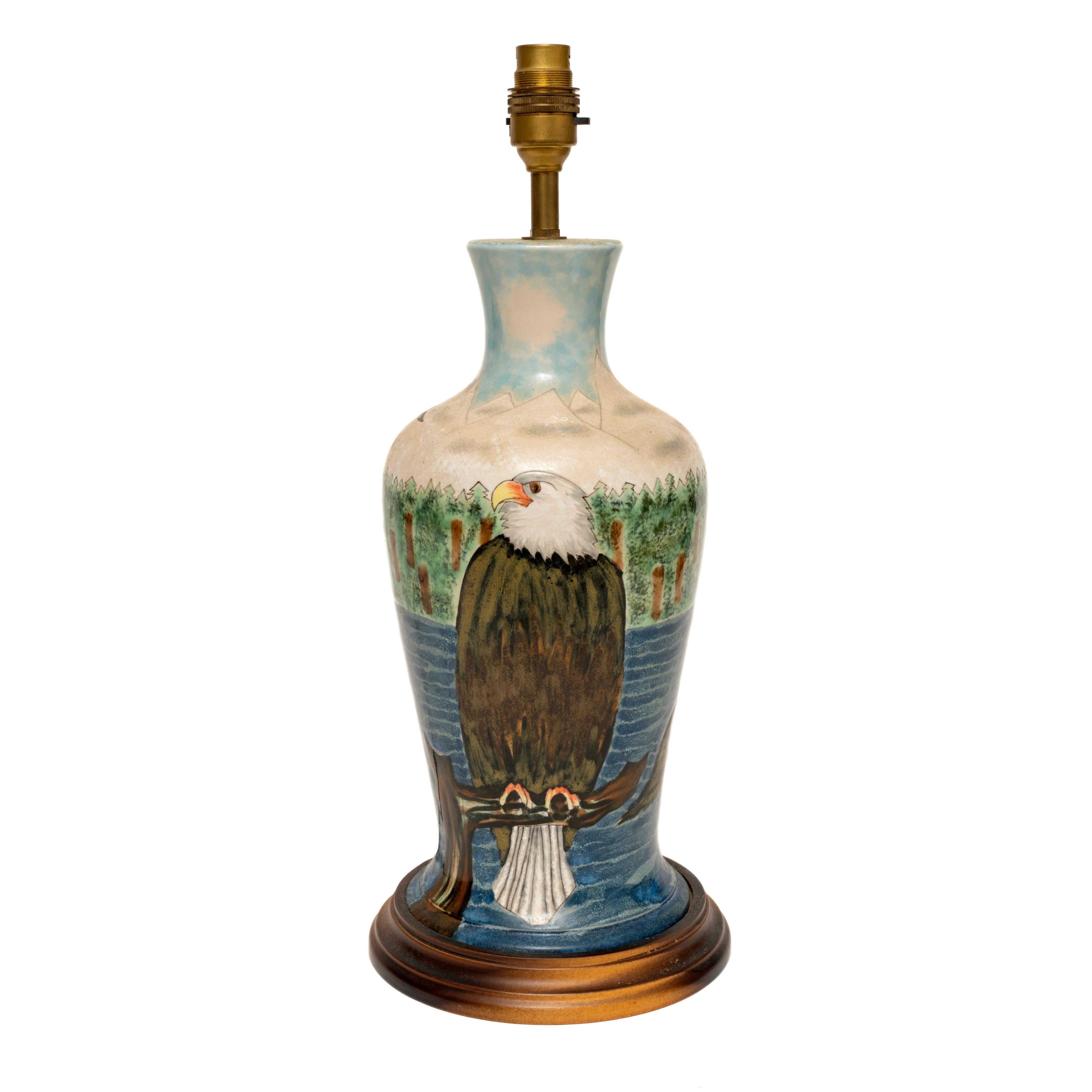 Cobridge stoneware : eagles catching fish with owl hovering, table lamp, 43cm., 17” high
This lamp depicts the narrative of the eagle fishing
Of interest to the ornithologist or Cobridge collectors
The front with a large stylised eagle on a