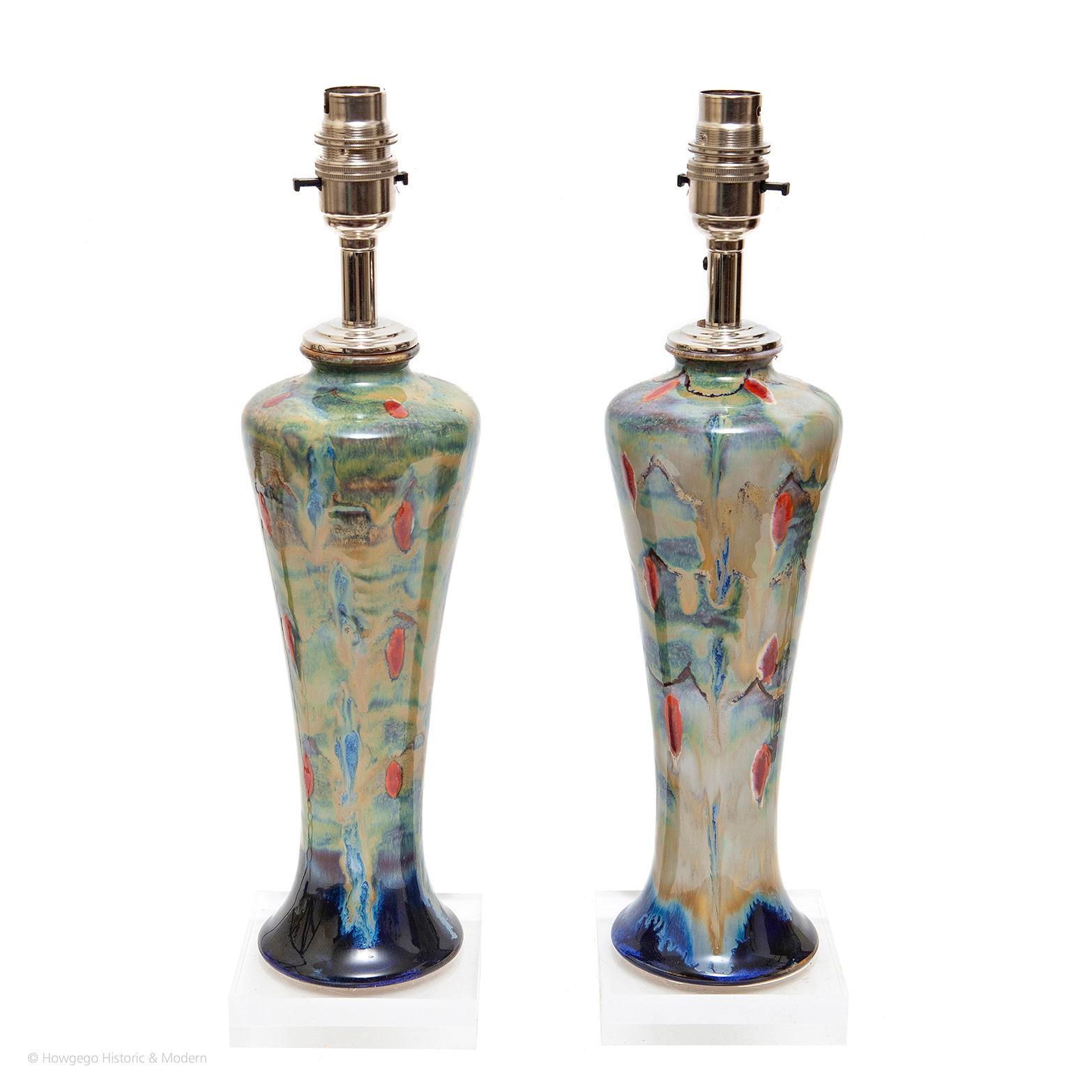 COBRIDGE, PAIR OF SAMBA PATTERN, HANDPAINTED VASES UPCYCLED INTO TABLE LAMPS ON PERSPEX BASES, 15½“ HIGH
One of Cobridge Pottery’s most popular patterns, designed by artist Anita Harris, leading designer at Cobridge, Moorcroft & her own studio