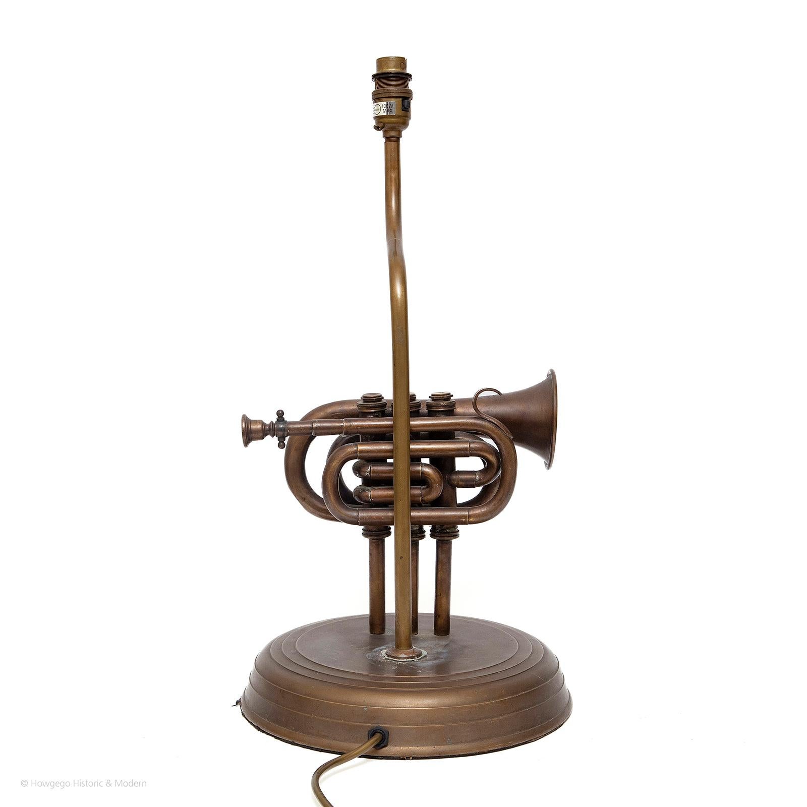 Vintage, brass, pocket trumpet, table lamp, 19½” high
A fun piece of signature and conversation mood lighting
Bore brass instrument pitched in Bb, used in brass bands, concert bands and occasionally orchestras. 
Inspired by the Besson pocket