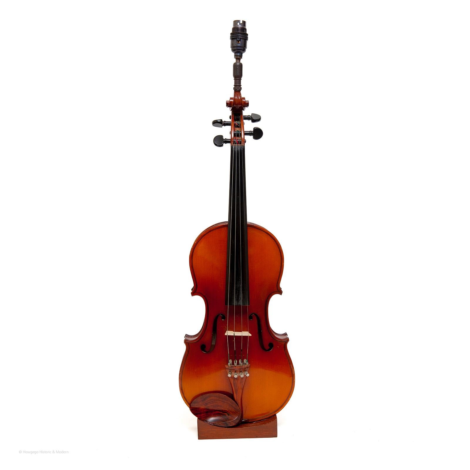 Vintage, violin upcycled into a table lamp, 29” high.
A fun piece of signature and conversation mood lighting which can also be played.
Injecting character and atmospheric into the interior.
PRICING £1,500.
Inspired by violins made by Ludwig