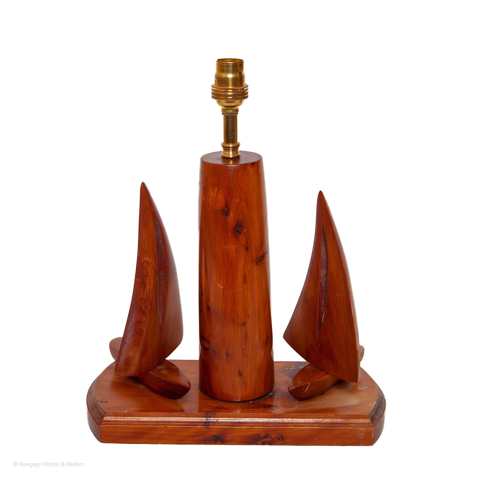 VINTAGE, YEWWOOD, TABLE LAMP, WITH TWO RACNG YACHTS WITH ADJUSTABLE SAILS, SAILING AROUND A LIGHTHOUSE OR BUOY, 13” HIGH

Interactive table lamp as the sails can be adjusted
Fun table lamp for a sailing enthusiast.
The yewwood has beautiful