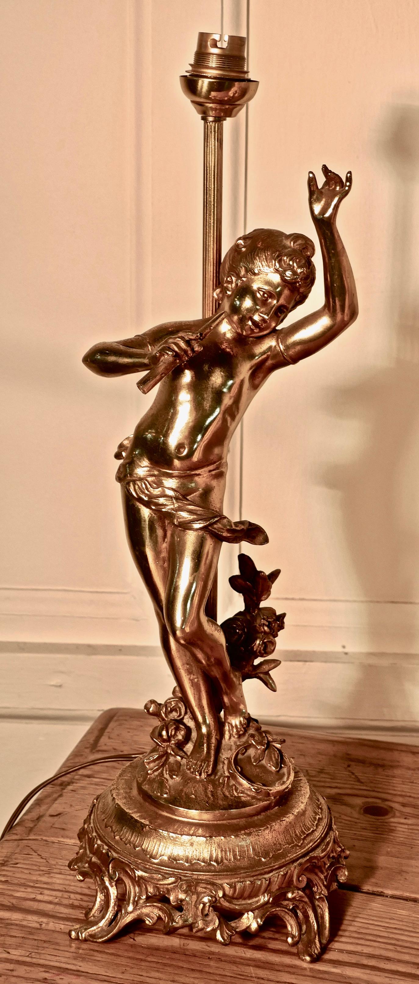 Lamp with a Dancing Cherub or French Brass Musician 

This charming piece dates from the last half of the 19th Century
The figure has a bright patina and is set on a deep foliate plinth, the cherub has holds a flute in one hand 
The lamp is in very